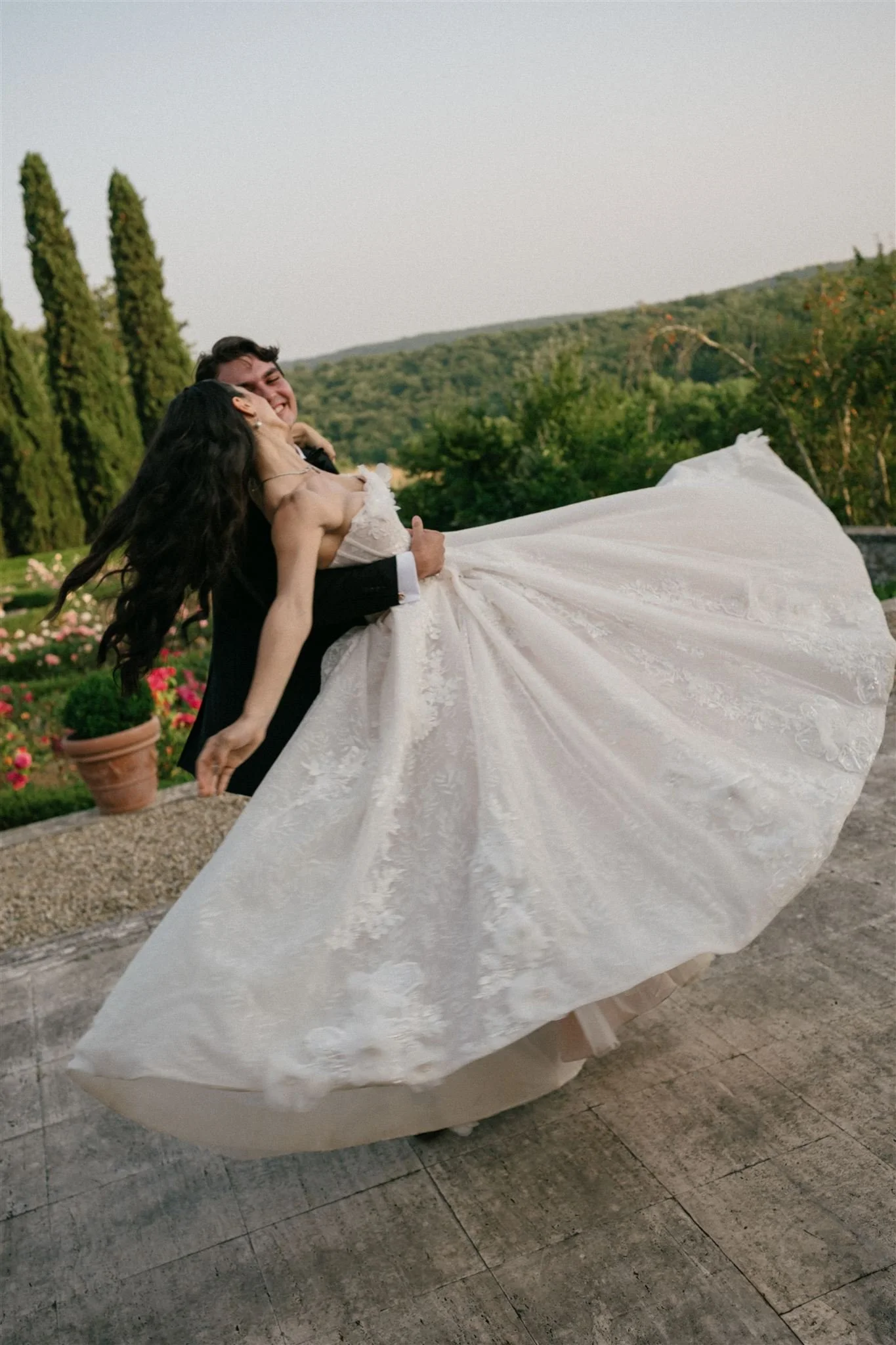 Bride and groom dancing overlooking Tuscan countryside