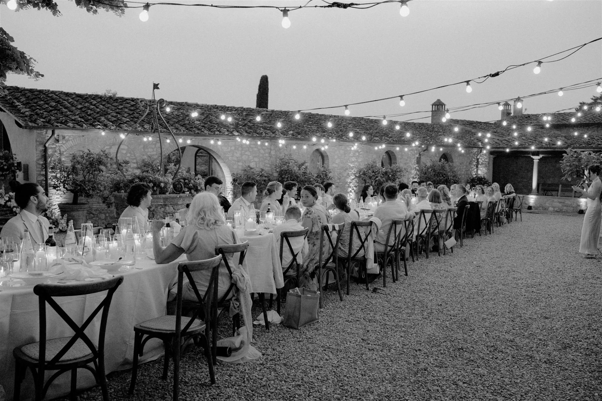 Evening wedding reception under string lights in Italy