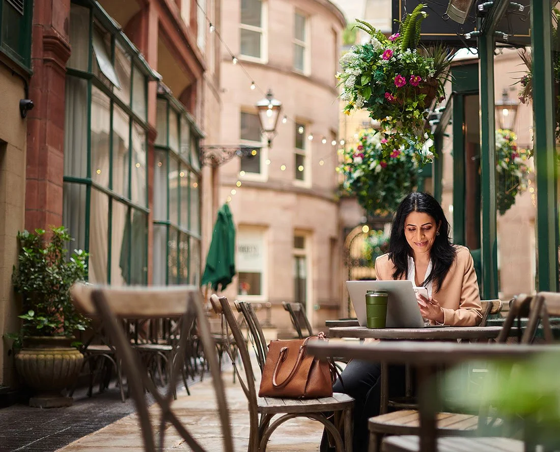 professional woman works at an outdoor cafe