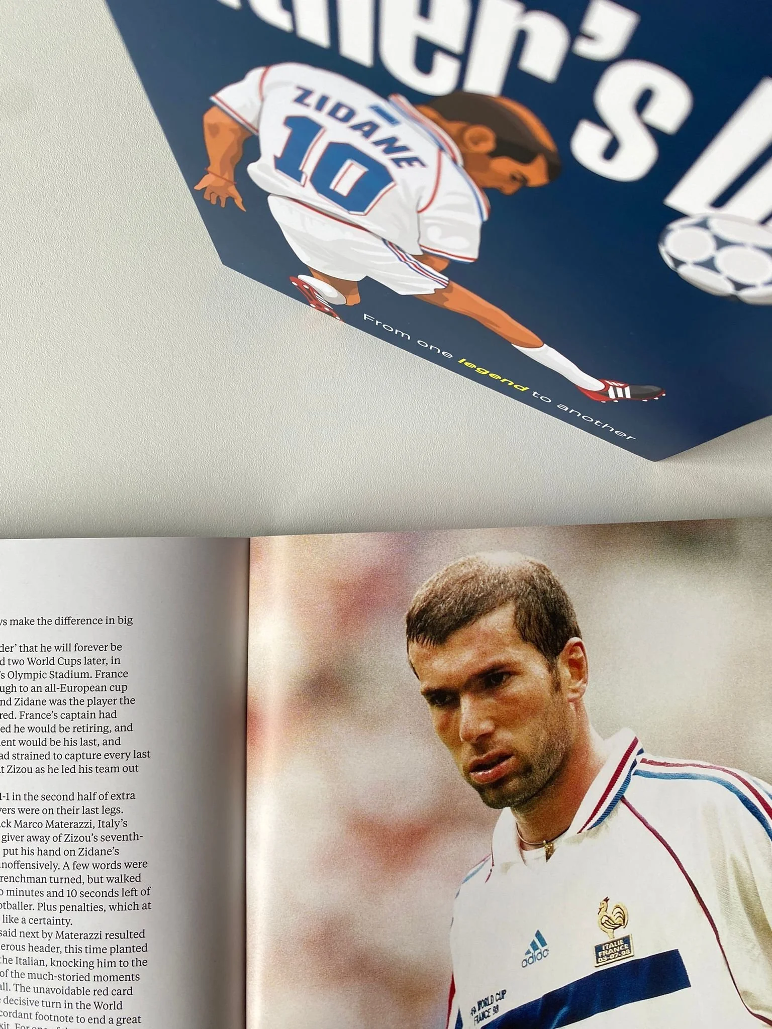 Photo of a magazine page featuring a football player in a white jersey, with a close-up portrait and a graphic illustration of the same player on the cover of a book or magazine.