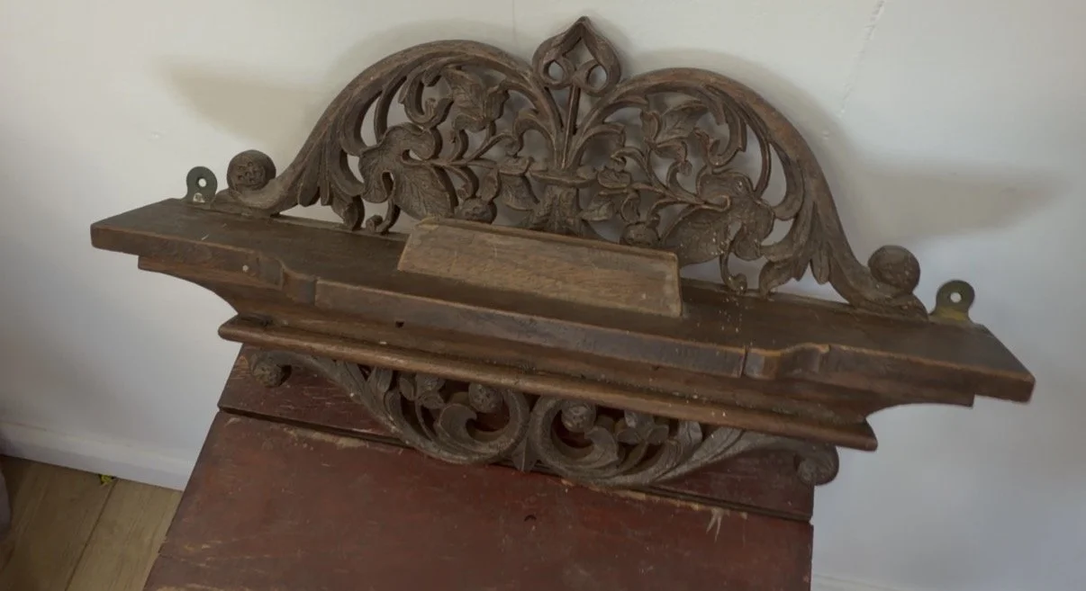 Antique hand-carved wooden shelf with small hooks underneath and an unusual ridge, found at Kempton Park Antiques Market — can you help us identify it?