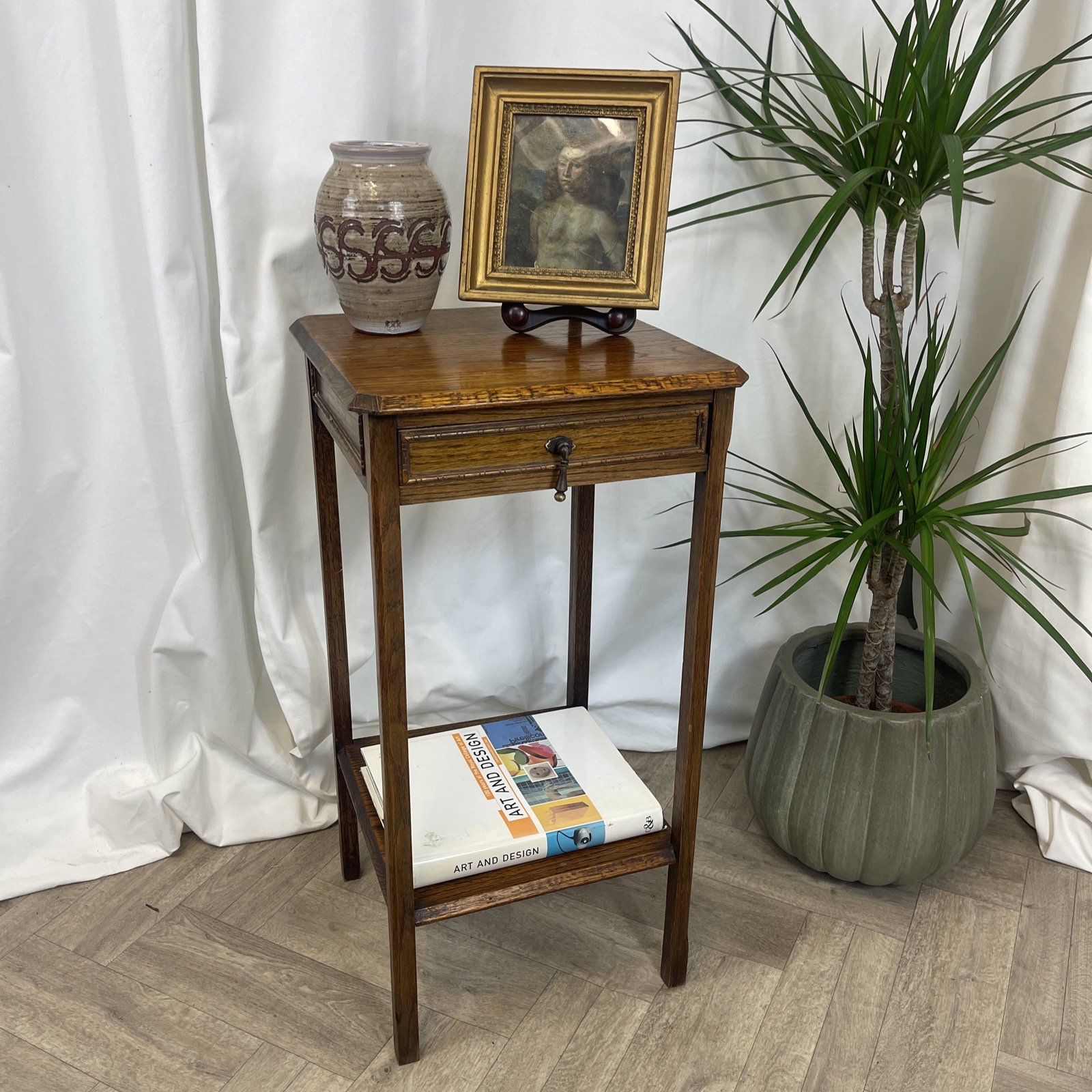 Antique tall side table made from oak with brass.