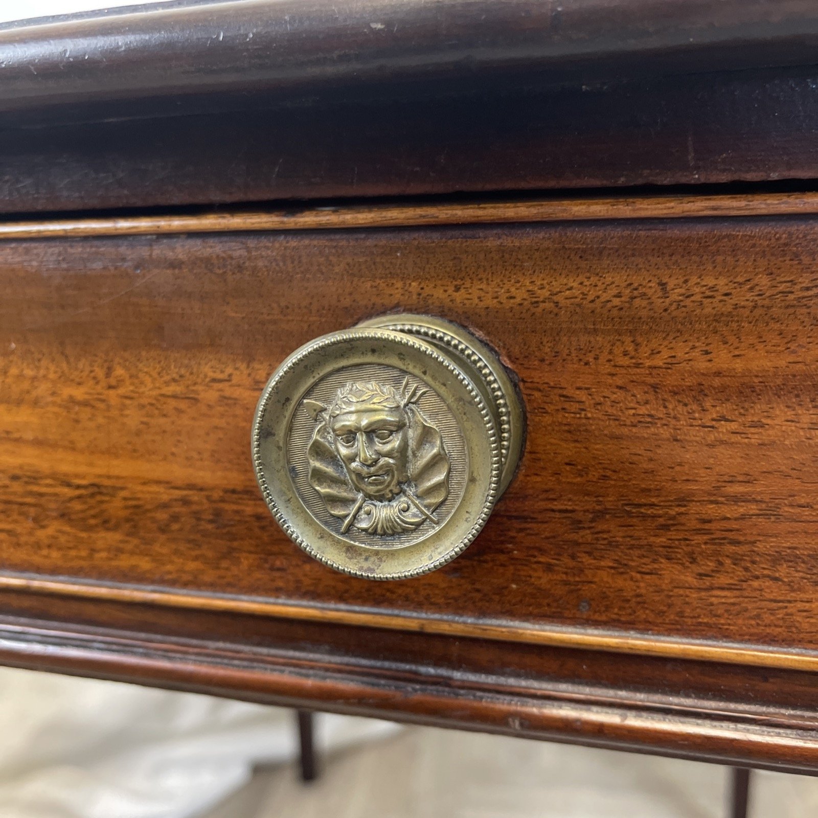 Antique mahogany dining table with brass handles