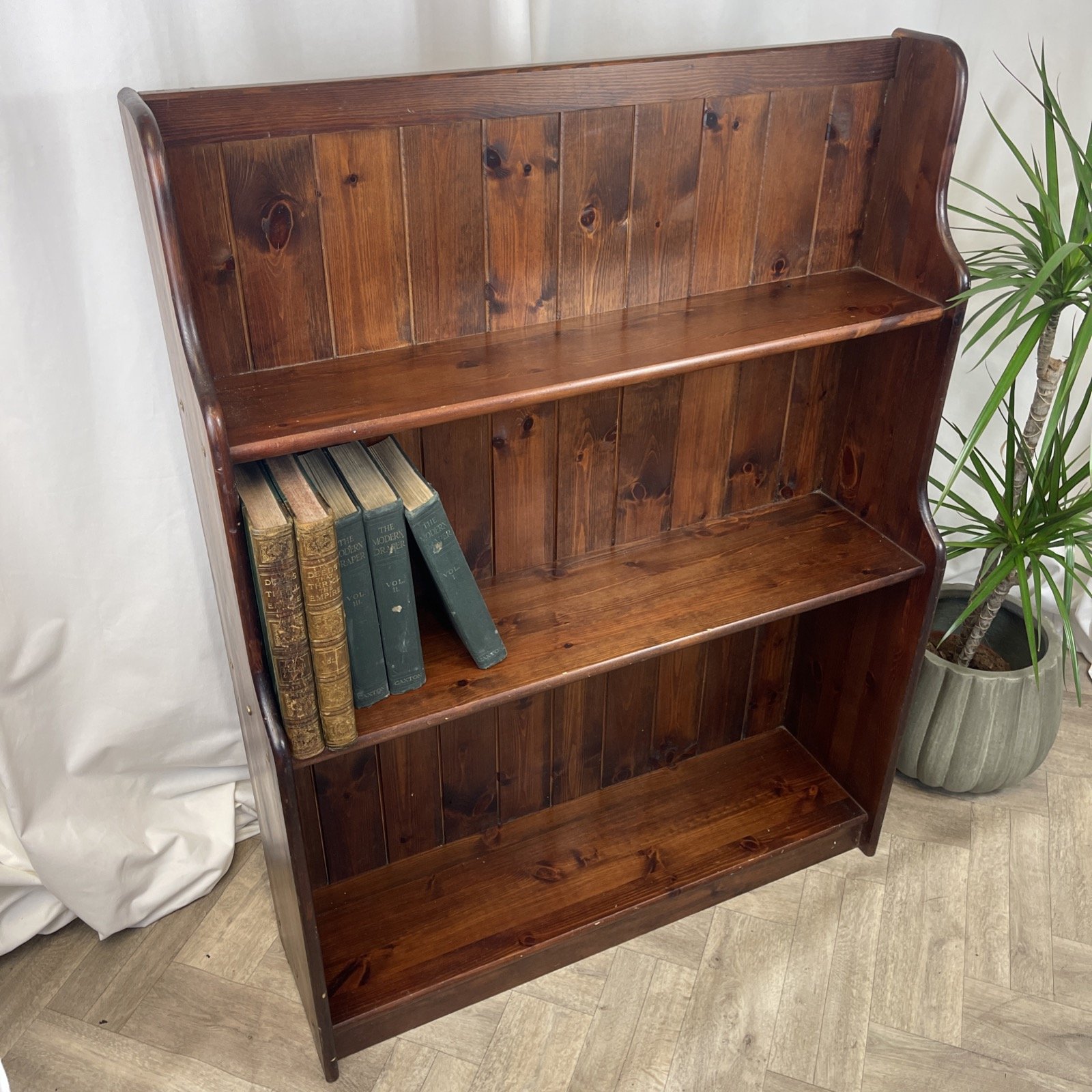 dark stained pine wooden shelf book case