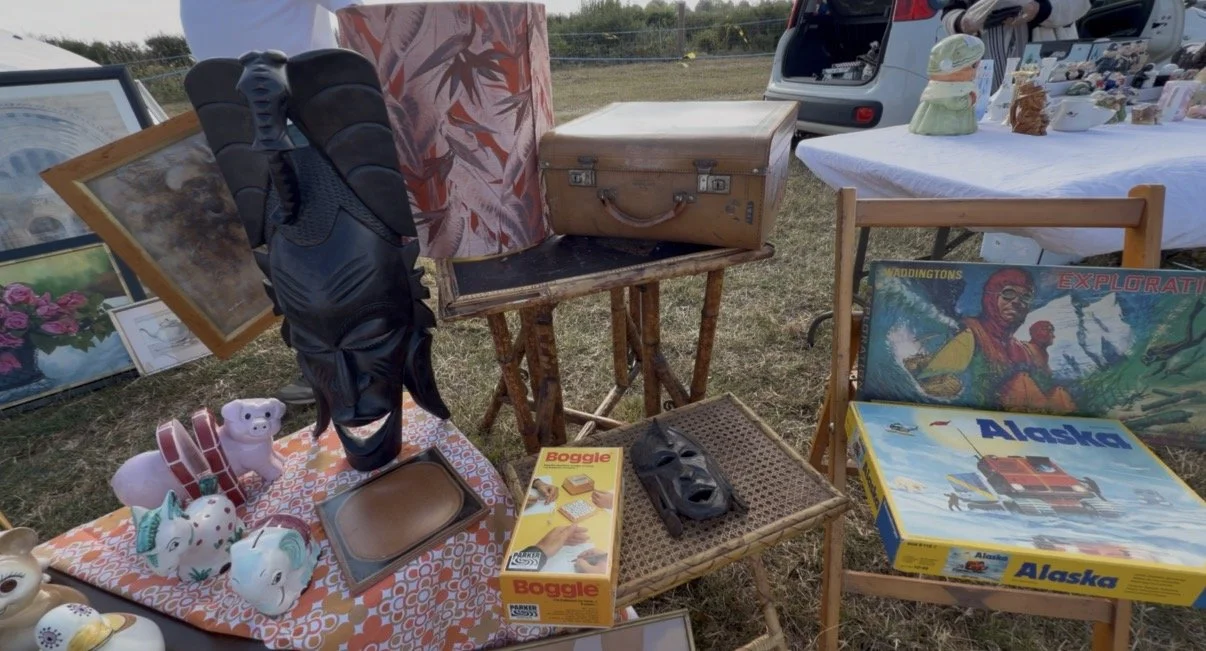 Vintage stall display with mid-century ceramics arranged on a bamboo table at a village boot sale in Essex, from Fire and Wolf Interiors' clear-out sale.