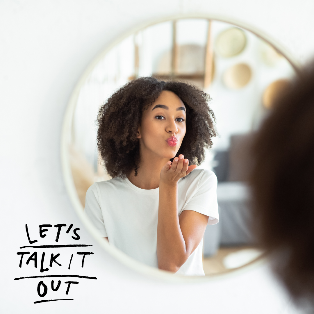 black woman dong positive self talk in the mirror