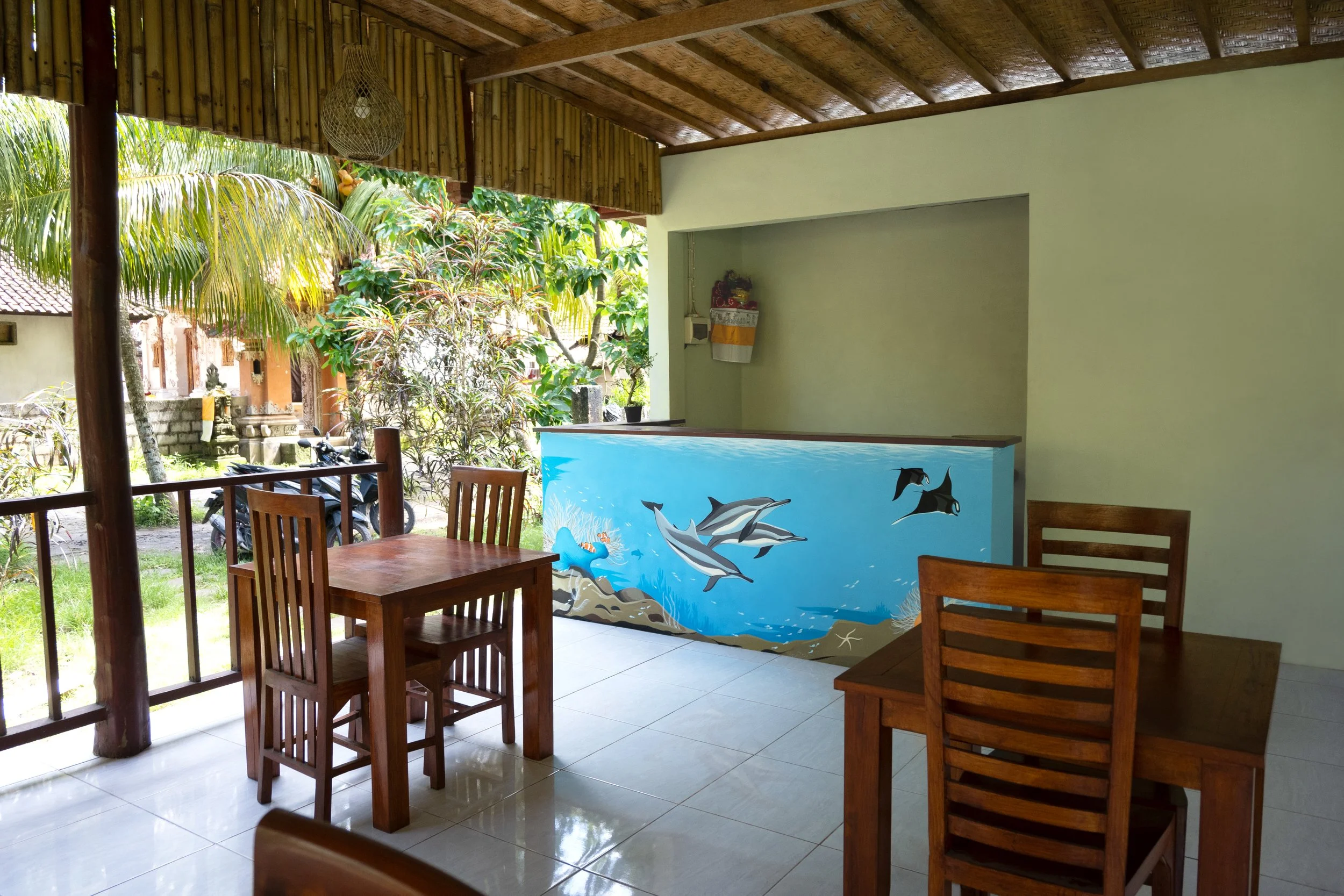 Puri Yalus Homestay - Spinner dolphins pass by the reef of a crystal clear bay. Painted on the reception wall in Crystal Bay area. 