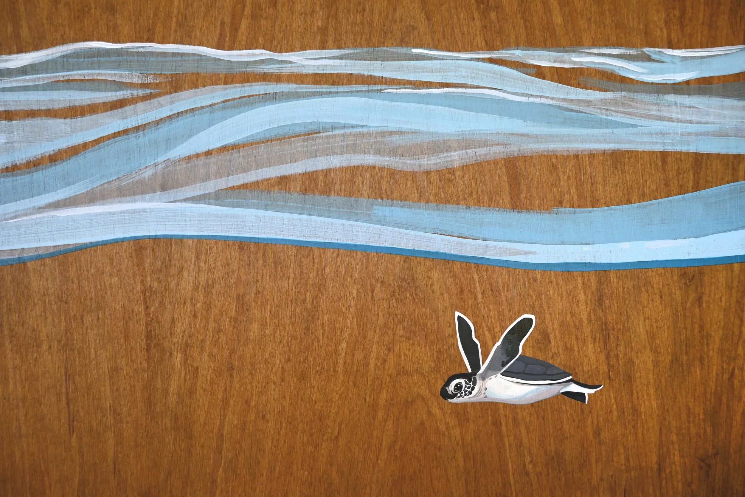 Kirana Retreat - A lively underwater scene featuring a variety of marine species. Painted on a wooden closet used to store watersport equipment at the resorts  watersport centre.