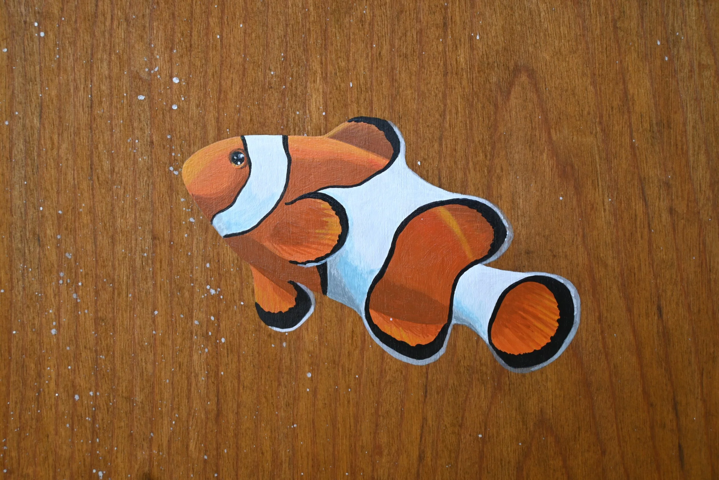 Kirana Retreat - A lively underwater scene featuring a variety of marine species. Painted on a wooden closet used to store watersport equipment at the resorts  watersport centre.