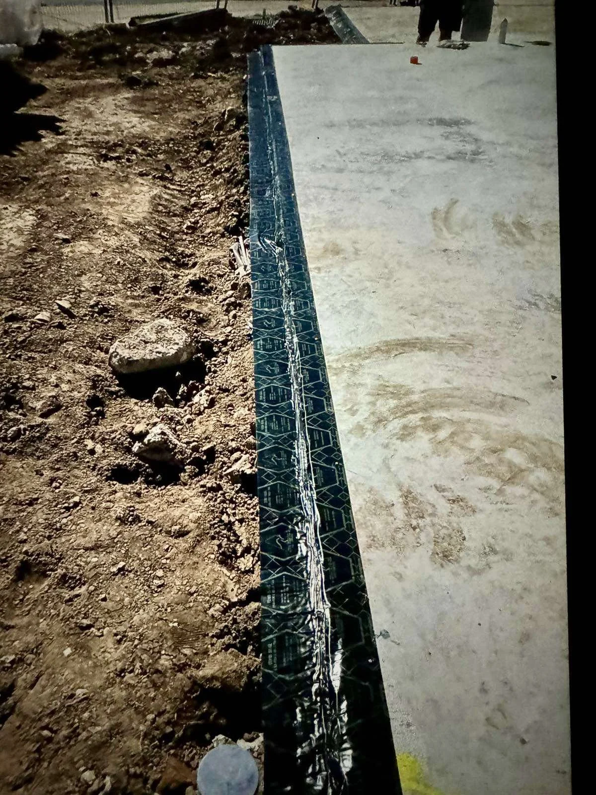 Physical termite management barrier installed during construction to help protect a building from concealed termite entry