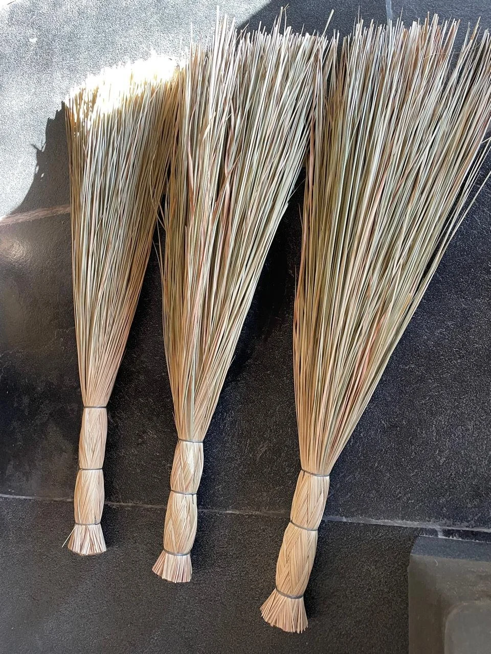 Brooms made of 'weed' grasses