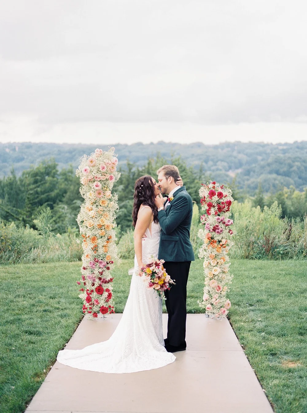 Ceremony floral pillars with bride and groom