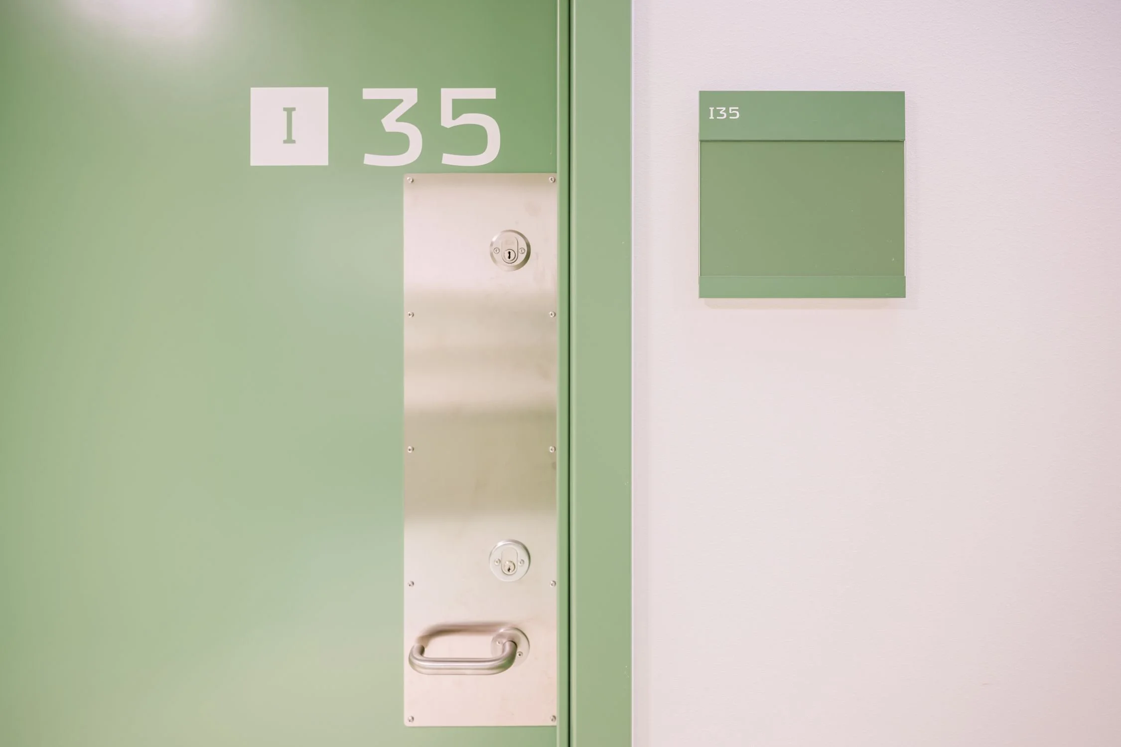 Interior view of a prison doorway at Sønder Omme Prison with integrated wayfinding signage