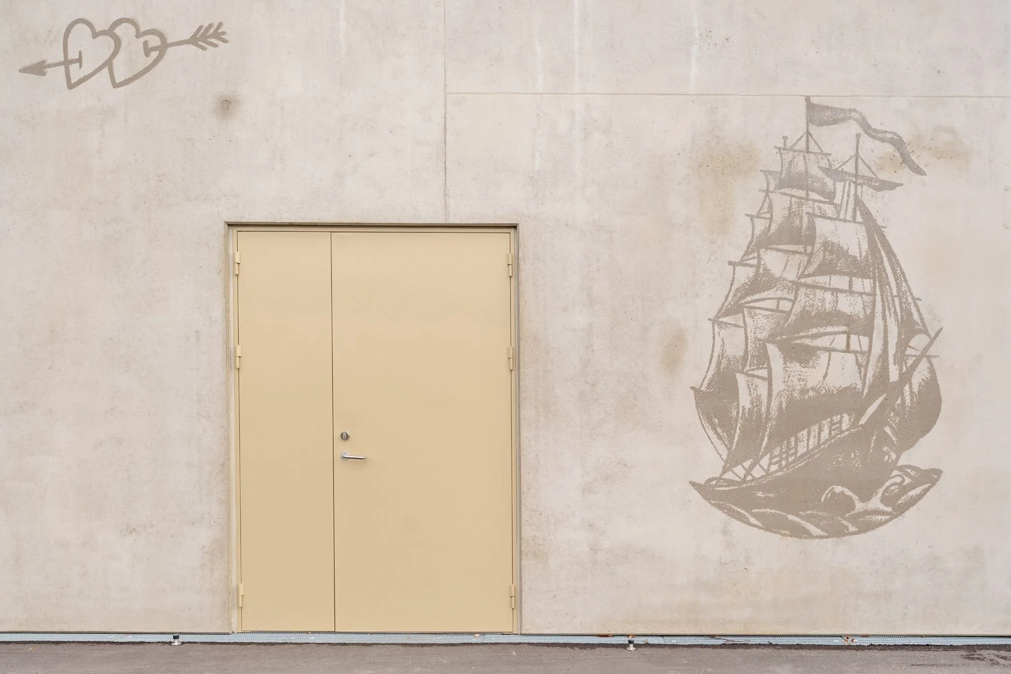 Exterior facade with ship and heart artwork at Sønder Omme Prison