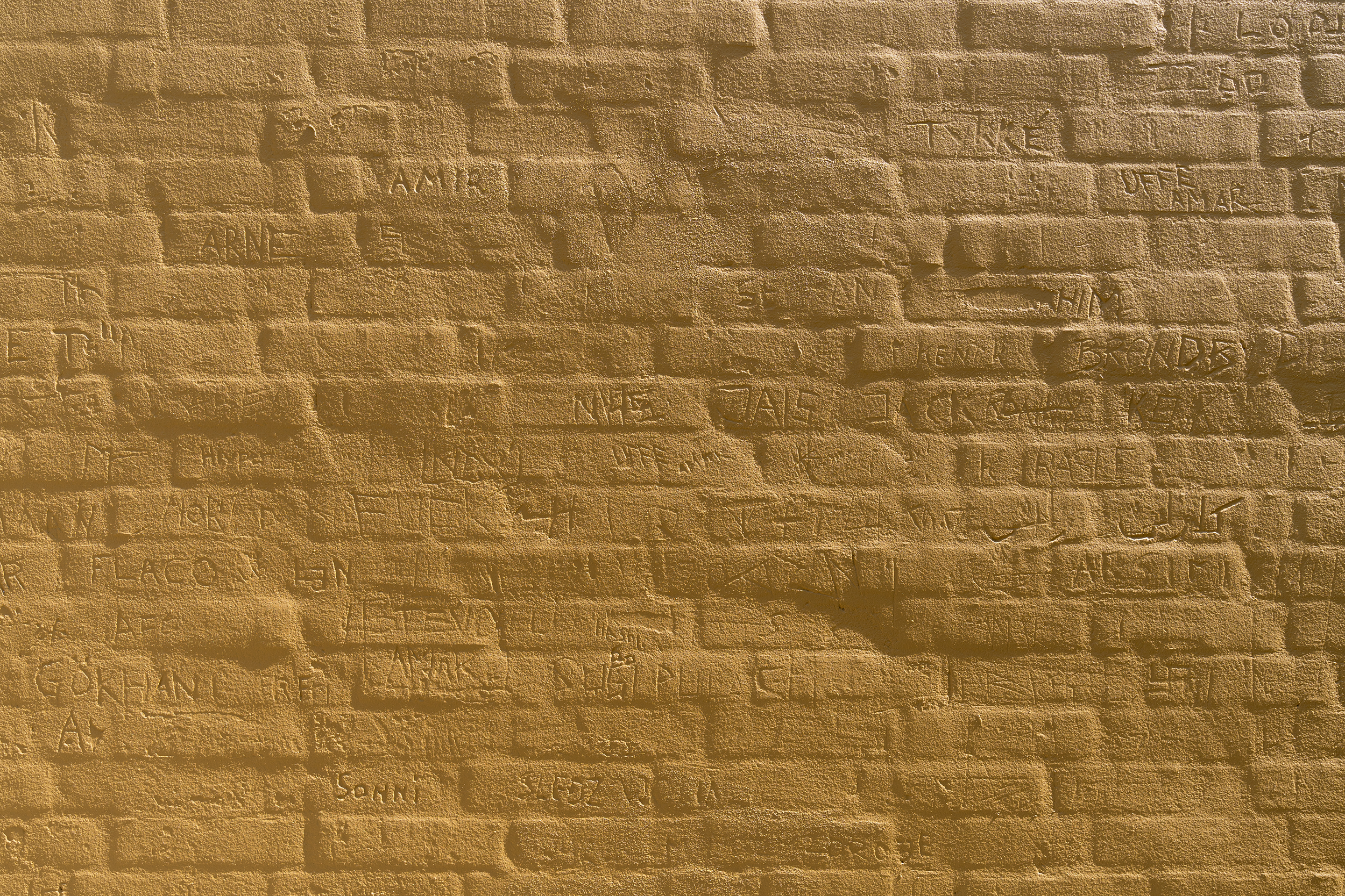 Yellow wall with writing detail at Maribo Halfway House.