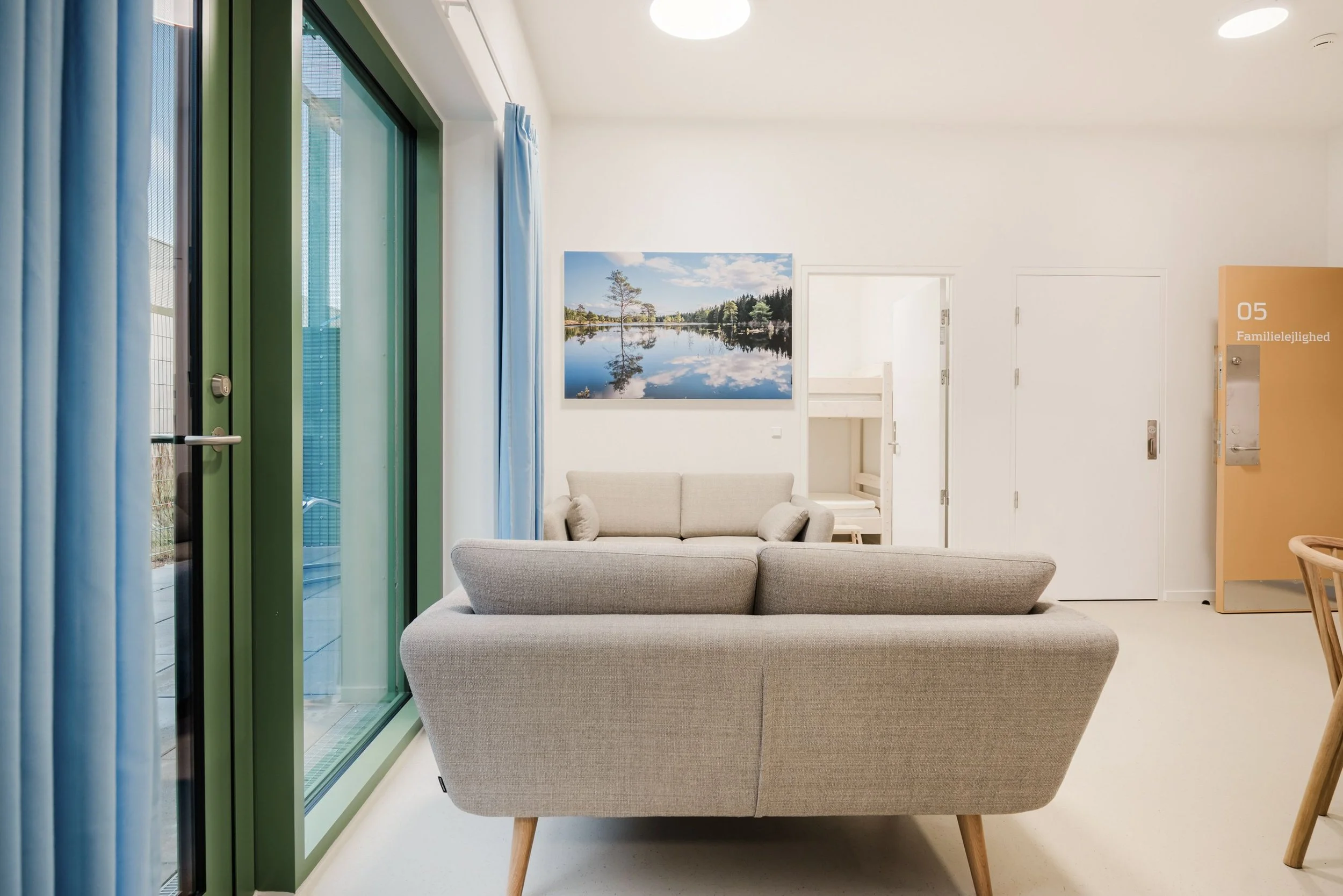 Interior view of a family unit living room at Sønder Omme Prison with natural light