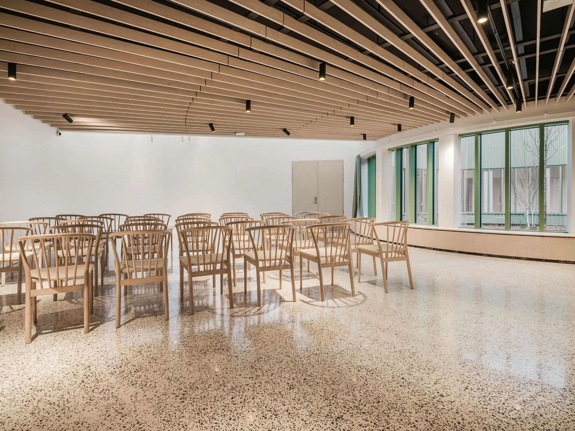 Interior view from the community house looking out towards the courtyard at Sønder Omme Prison