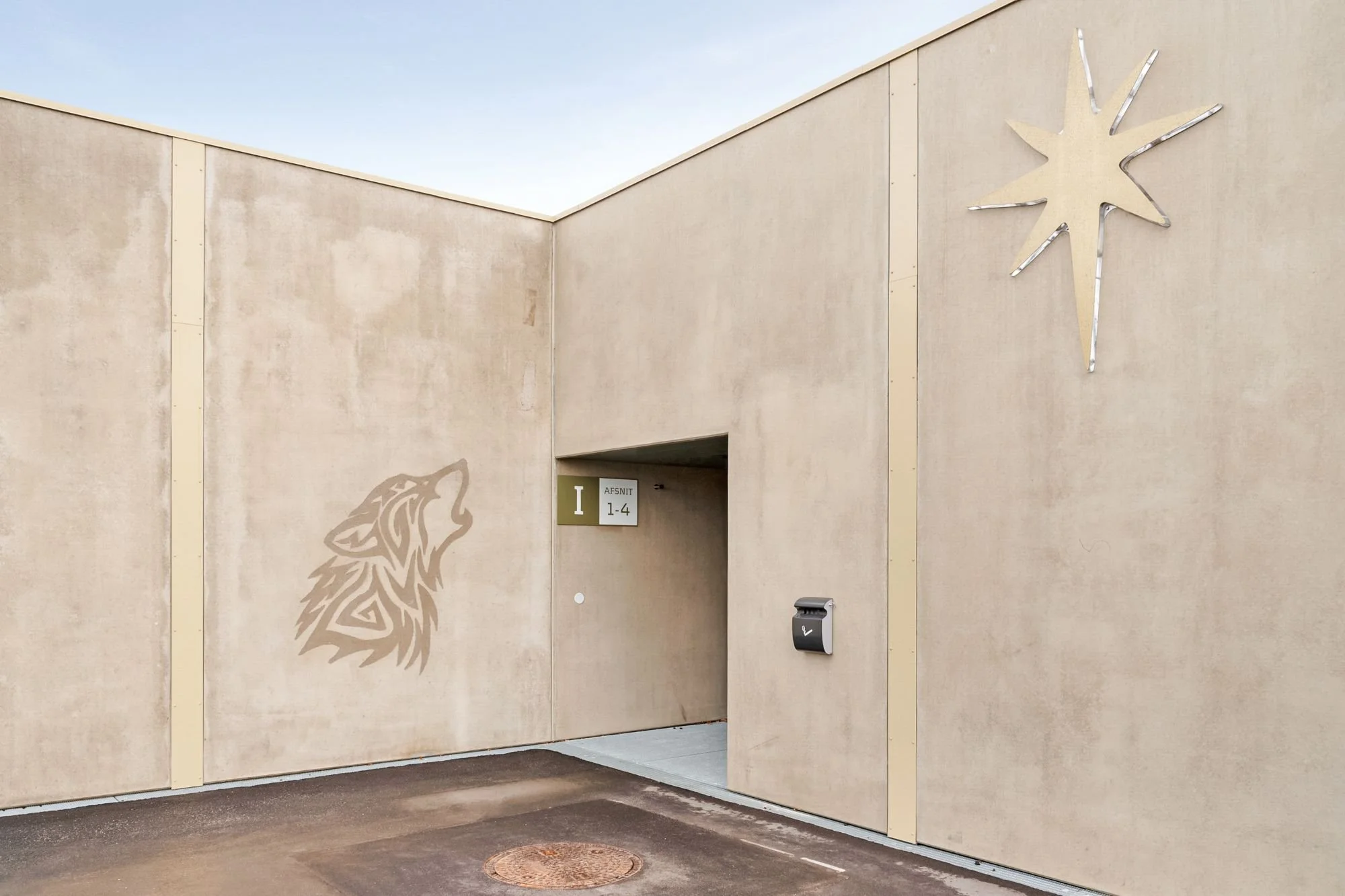 Exterior building facade at Sønder Omme Prison with integrated wolf artwork