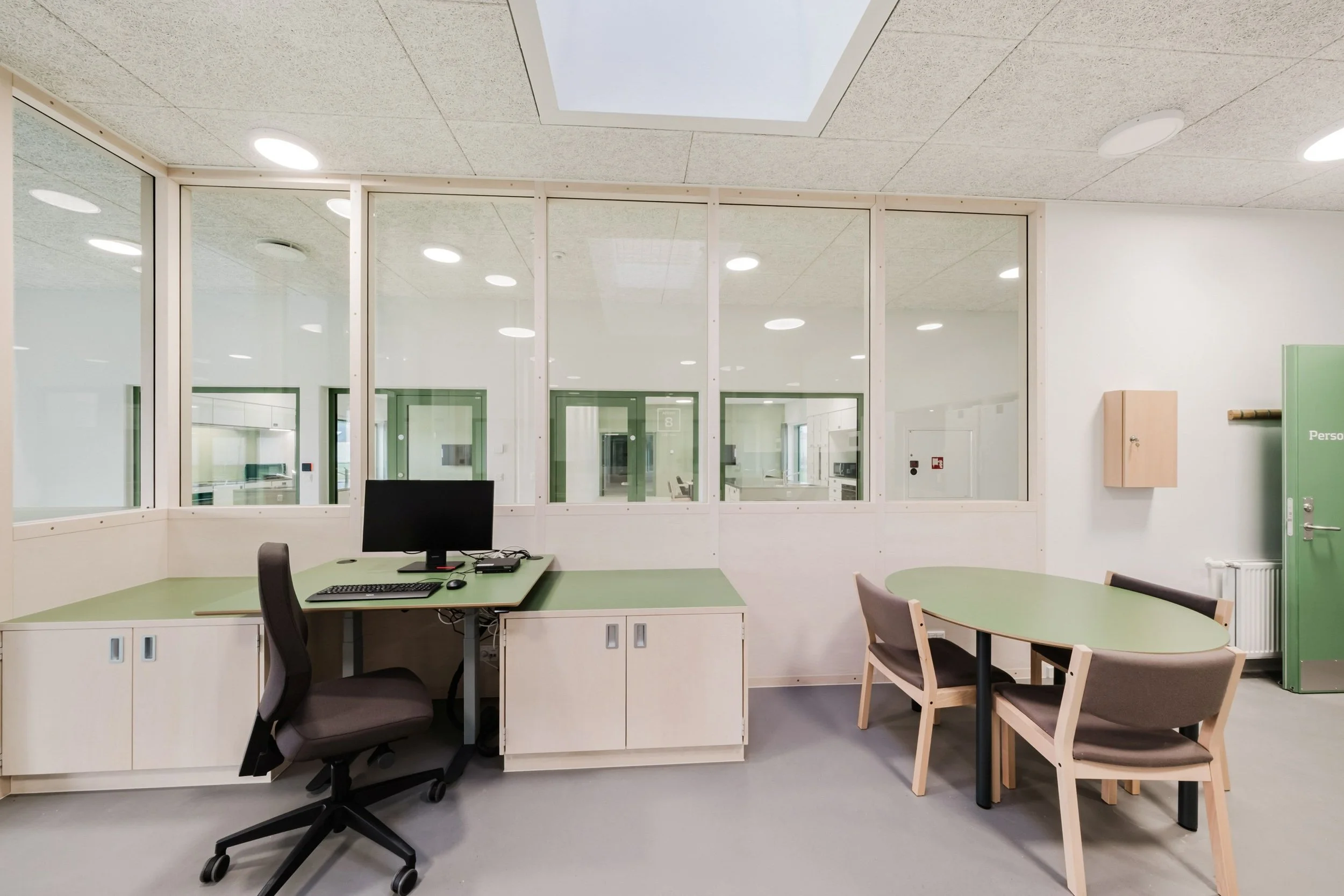 Interior view of the guard area at Sønder Omme Prison showing workspace and circulation