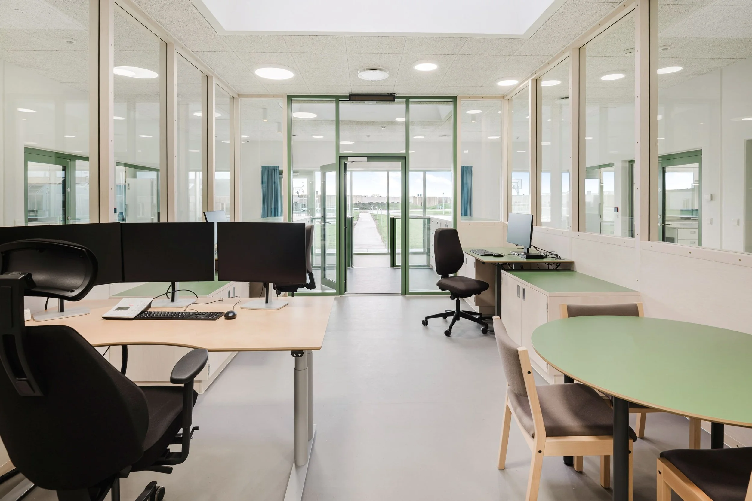 View from the guard area towards the exterior buildings and outdoor spaces at Sønder Omme Prison