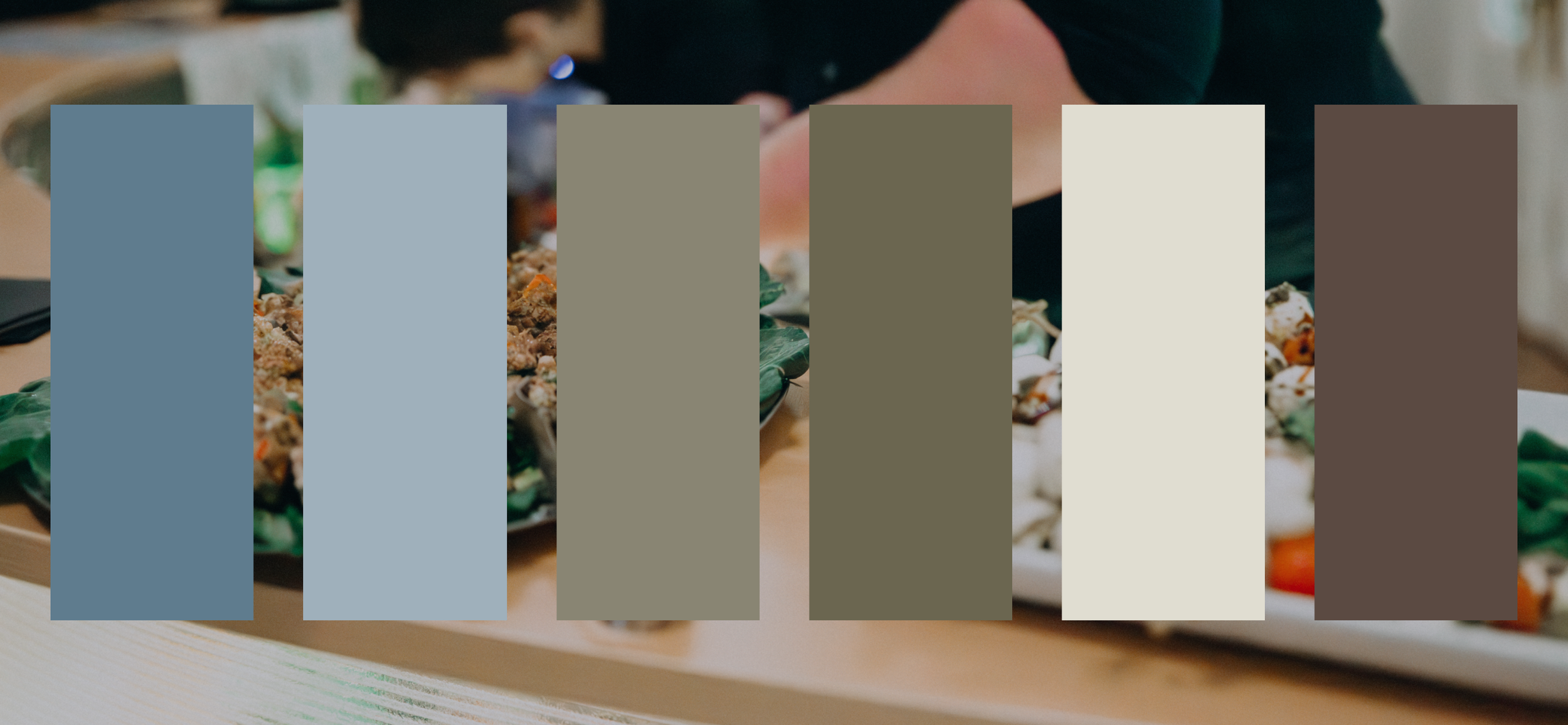 People gathered around a table with what appears to be food, possibly sushi or some other dish.