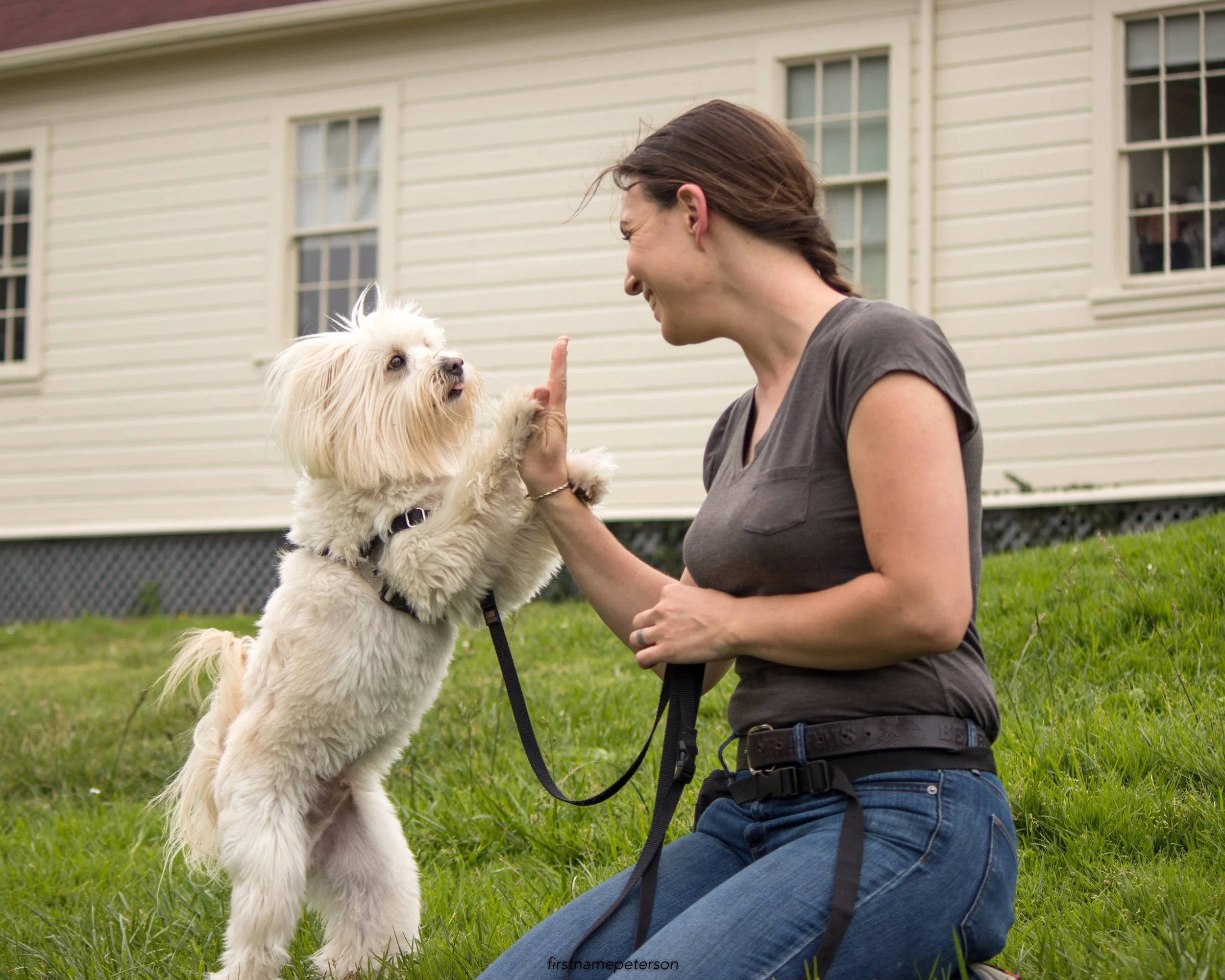 Angie high fiving her favorite long term boarding client.
