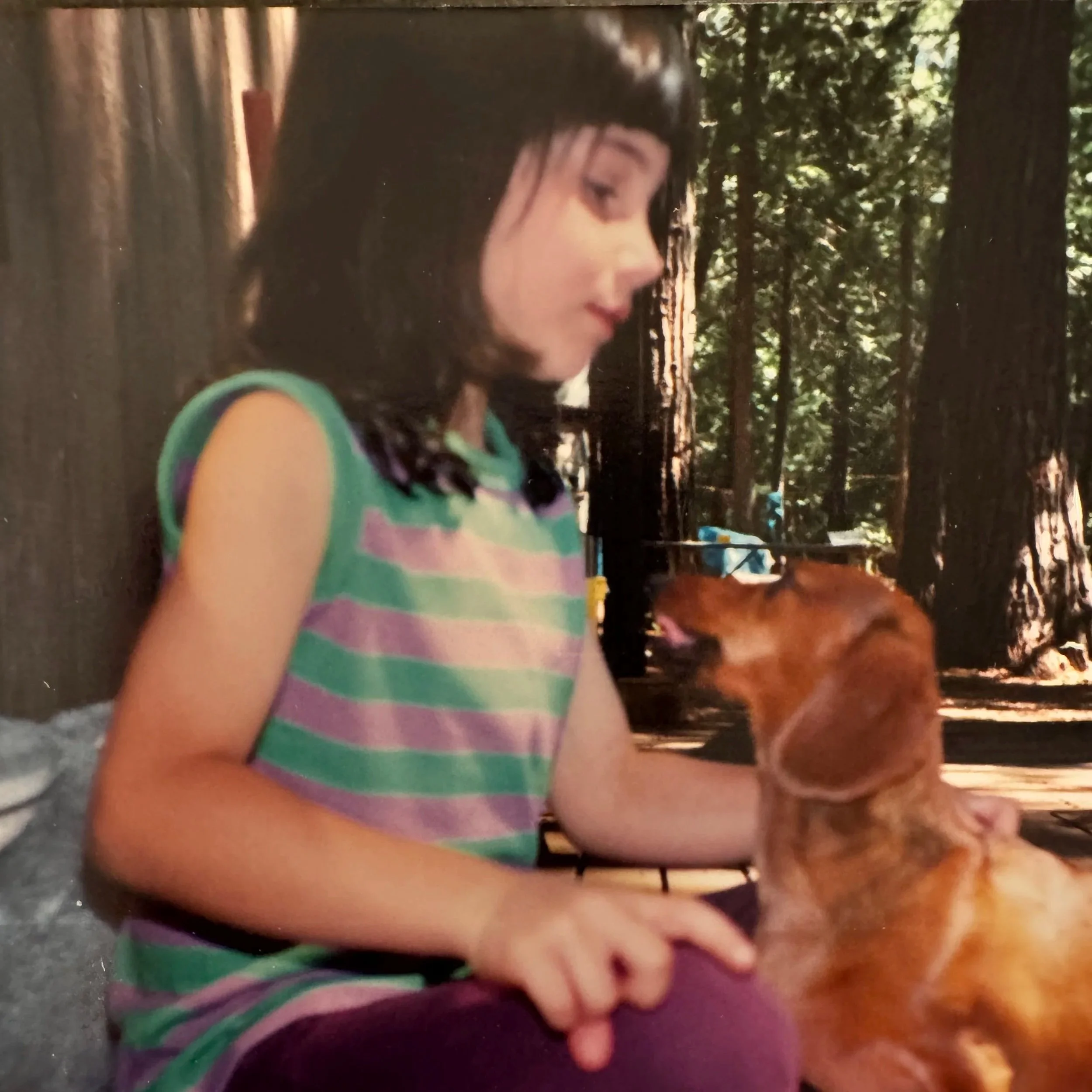 Young Angie with a dachshund dog 