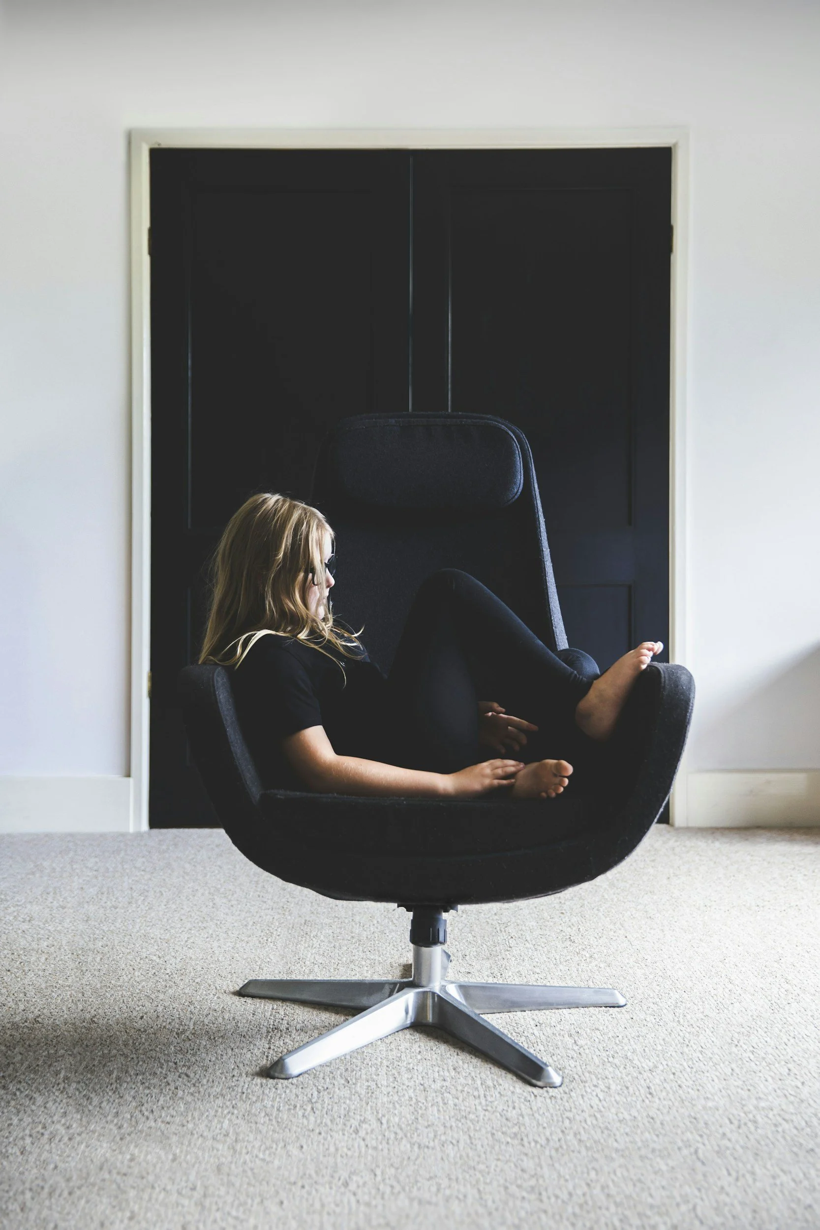 a Woman alone in chair feeling symptoms of loneliness and trauma