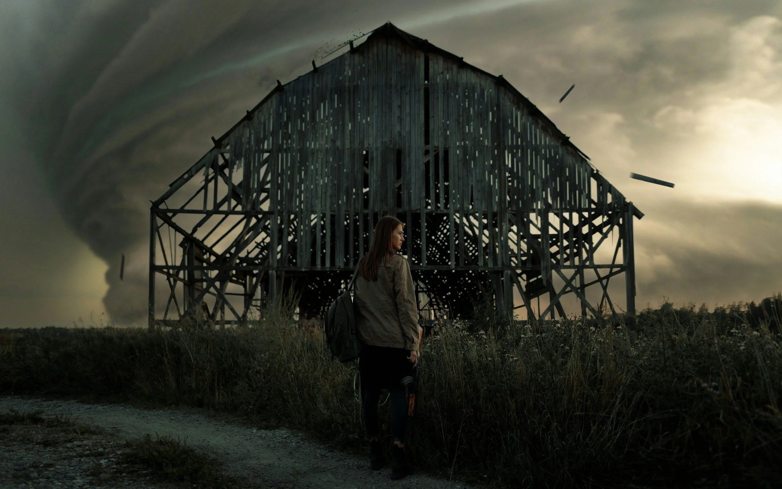 A young woman with a backpack standing in front of a dilapidated wooden house under a cloudy, stormy sky with tornado in the background.