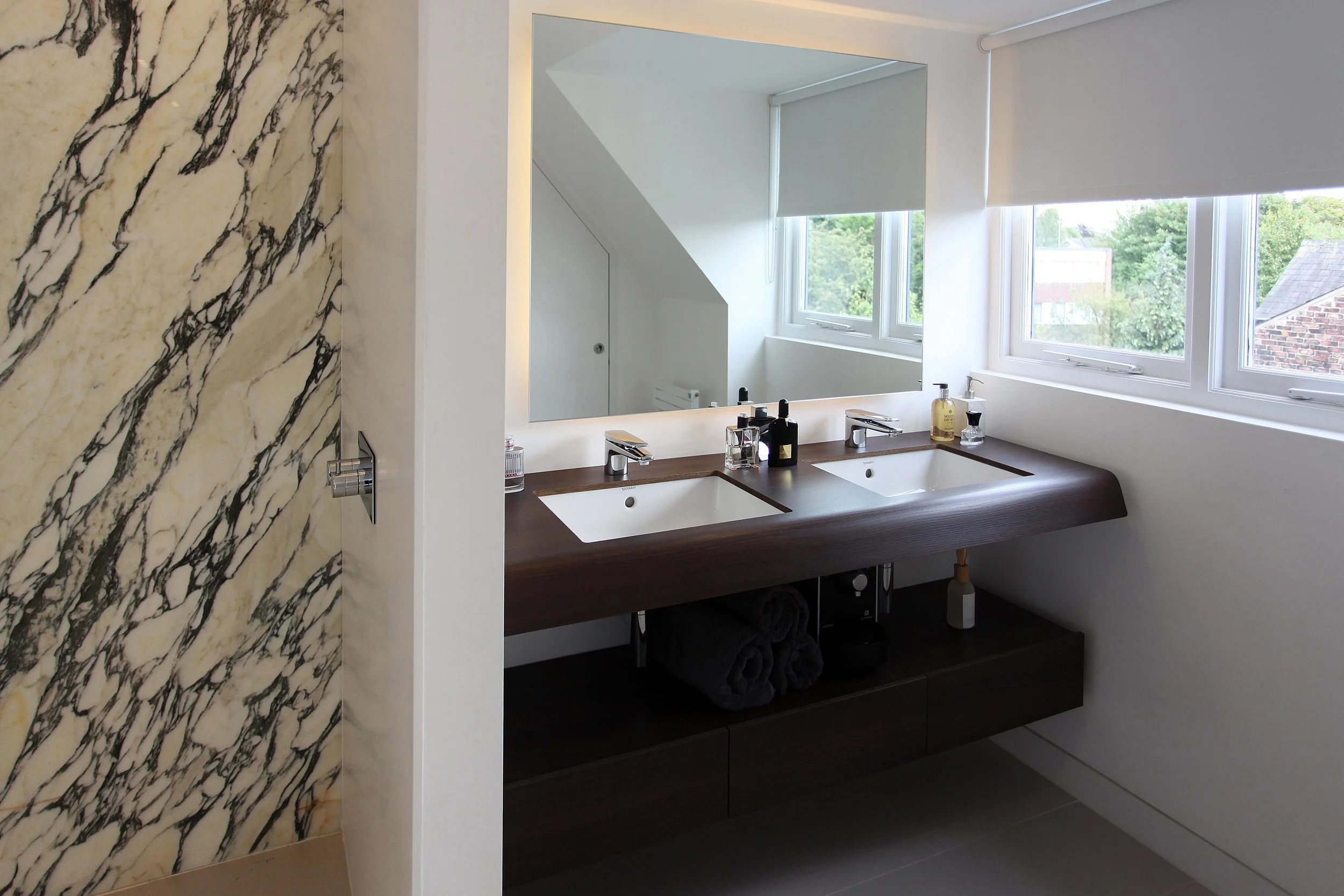 Contemporary wetroom in West Didsbury Victorian home with walk-in shower, marble tiles, and chrome fittings.