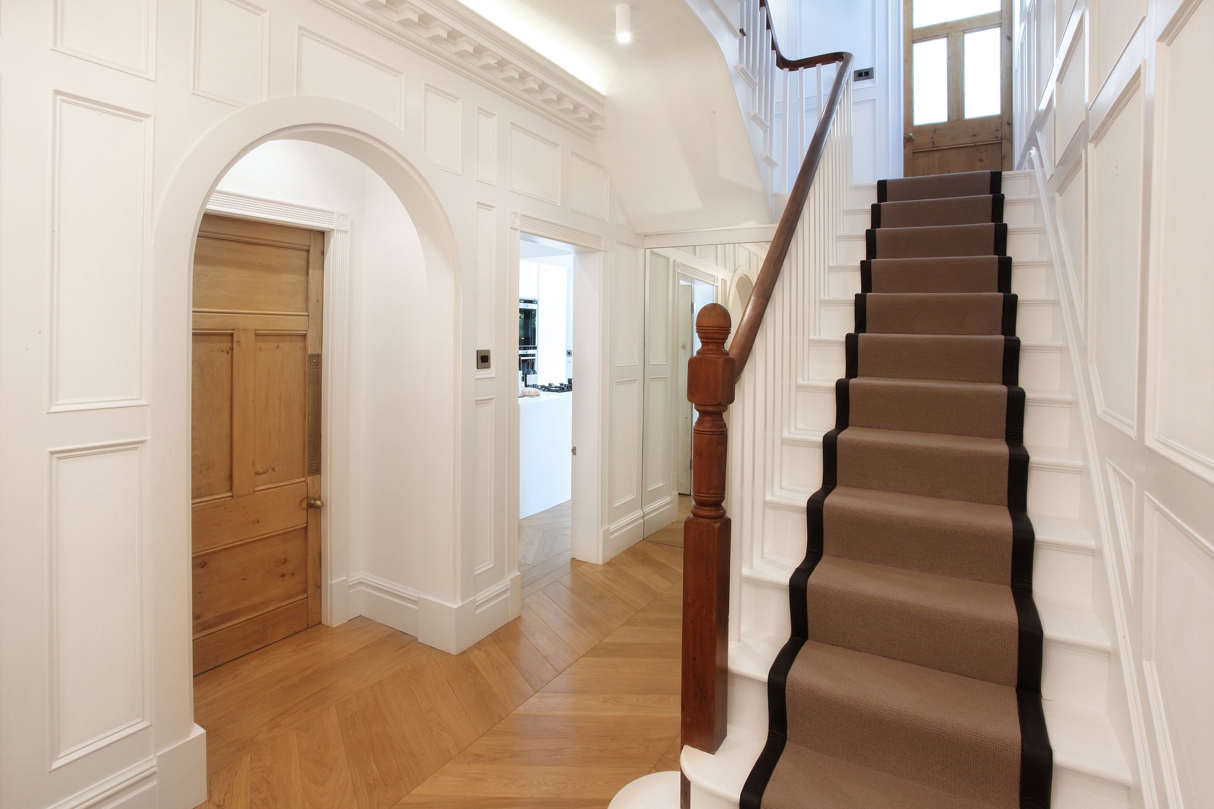 Refurbished interior with new sash windows, oak finishes, and bespoke joinery in Manchester extension project.