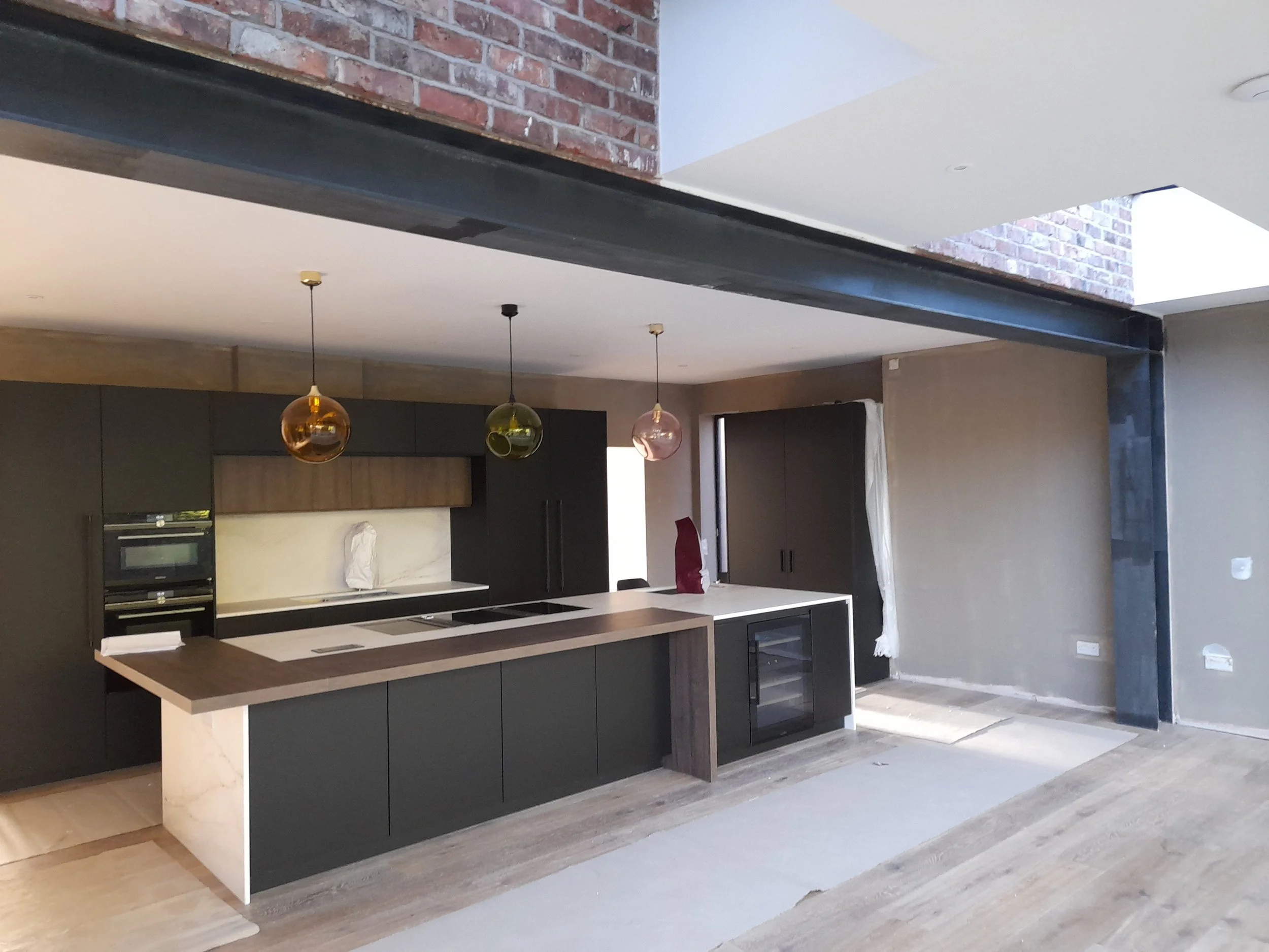 House refurbishment in progress with open-plan interior layout and structural steel installation, West Didsbury project