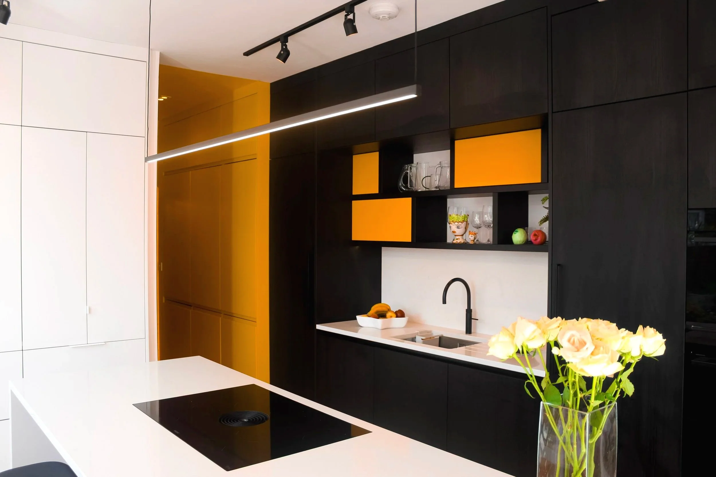 A modern house £80k rear kitchen extension with island, Bora hob, track lighting and dark wood cabinets in Chorlton, Manchester.
