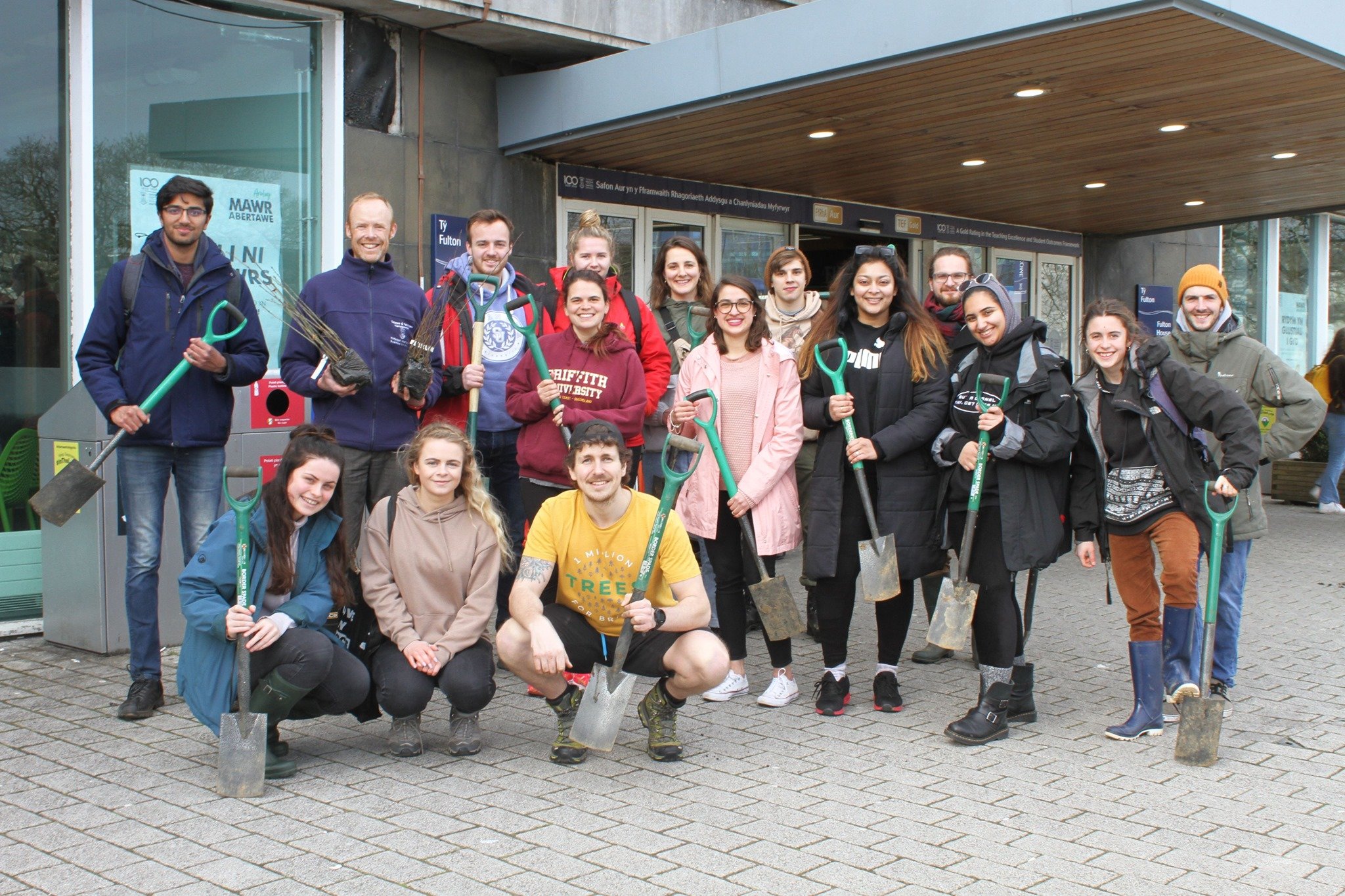students from swansea university posing outside of a building with their spades