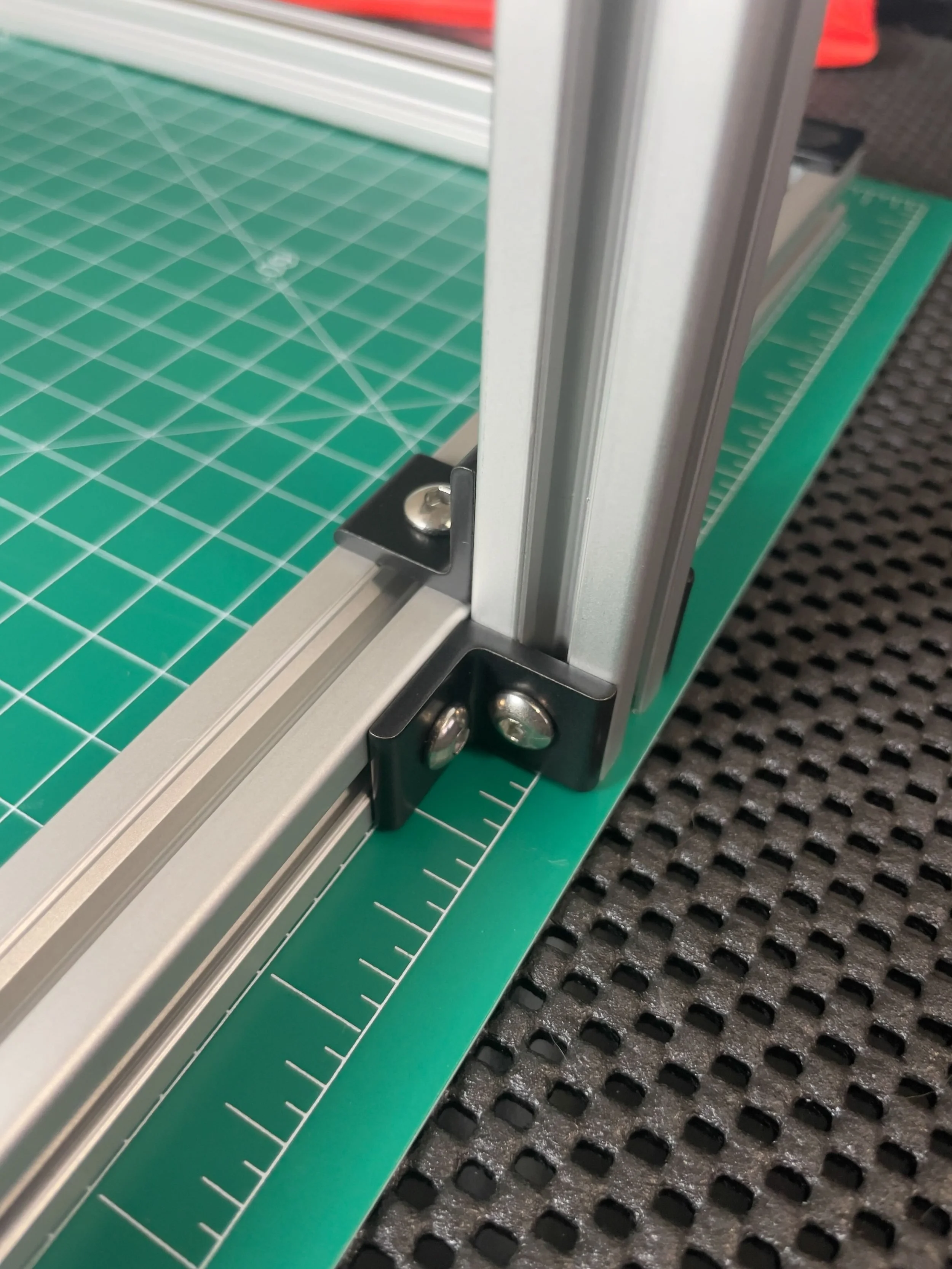 Two L-brackets on the back of the stand