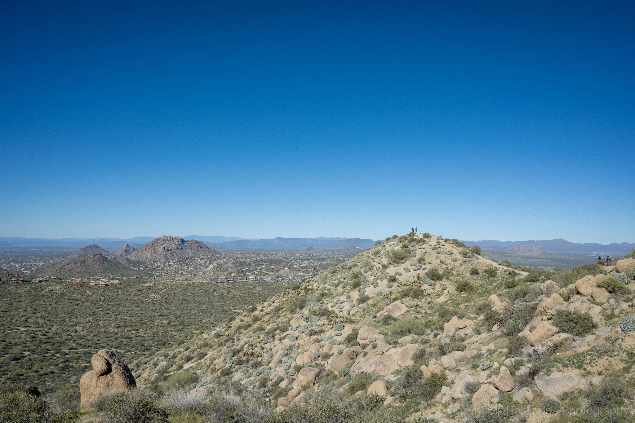 Two hiker stopping midway to admire the stretching horizon and Scottsdale.