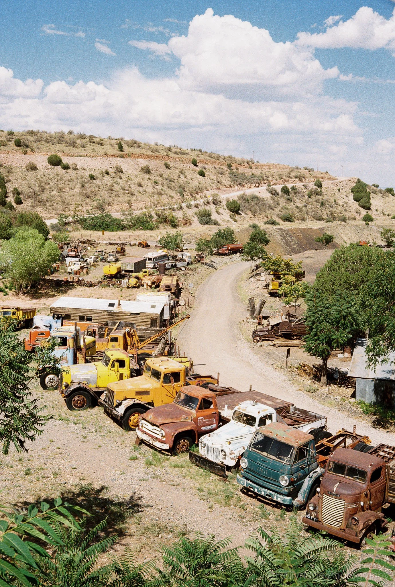 Vintage cars parked in Jerome, Arizona with desert hillside backdrop