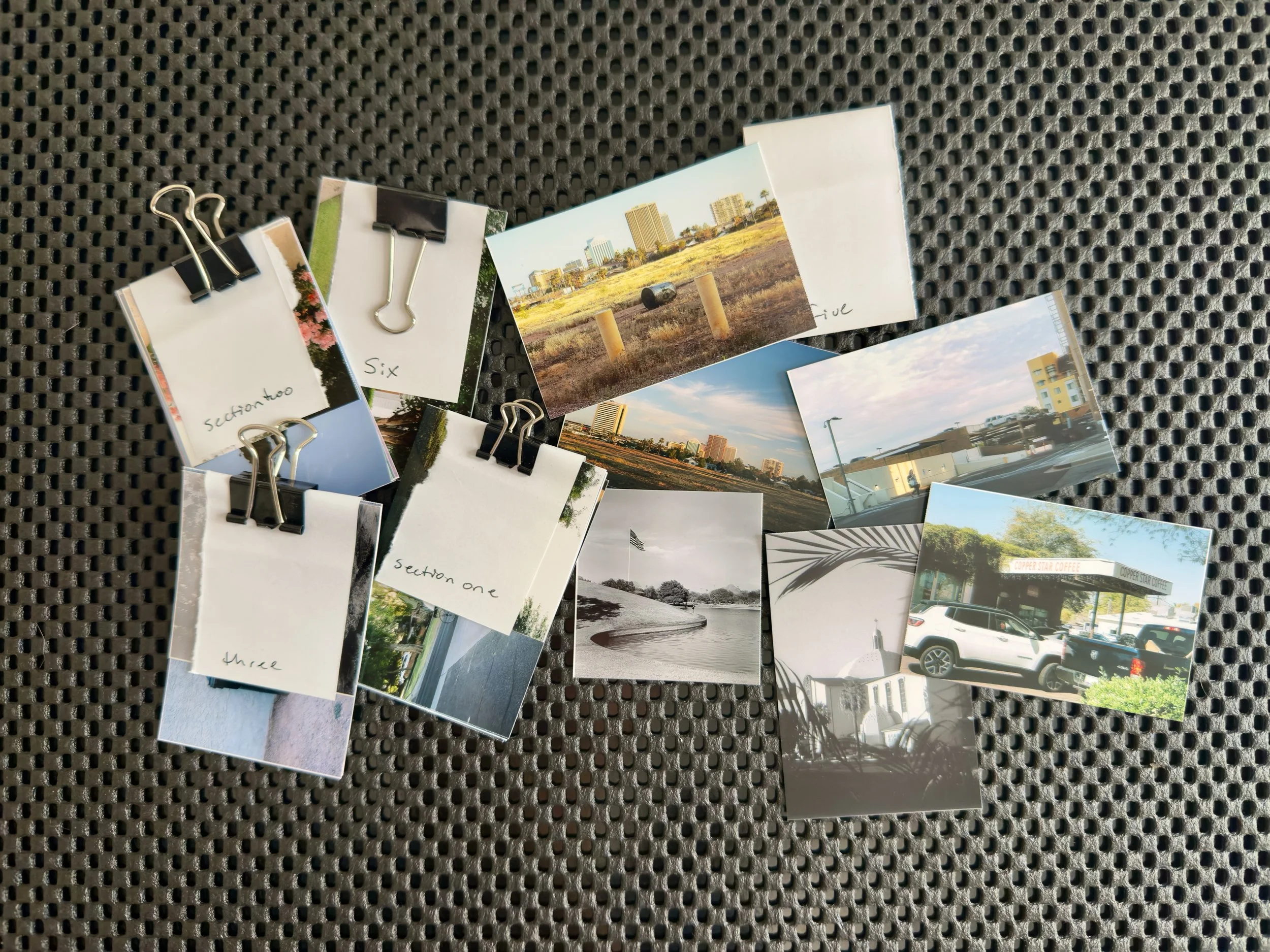 Early layout session with printed photo thumbnails clipped and grouped by section.