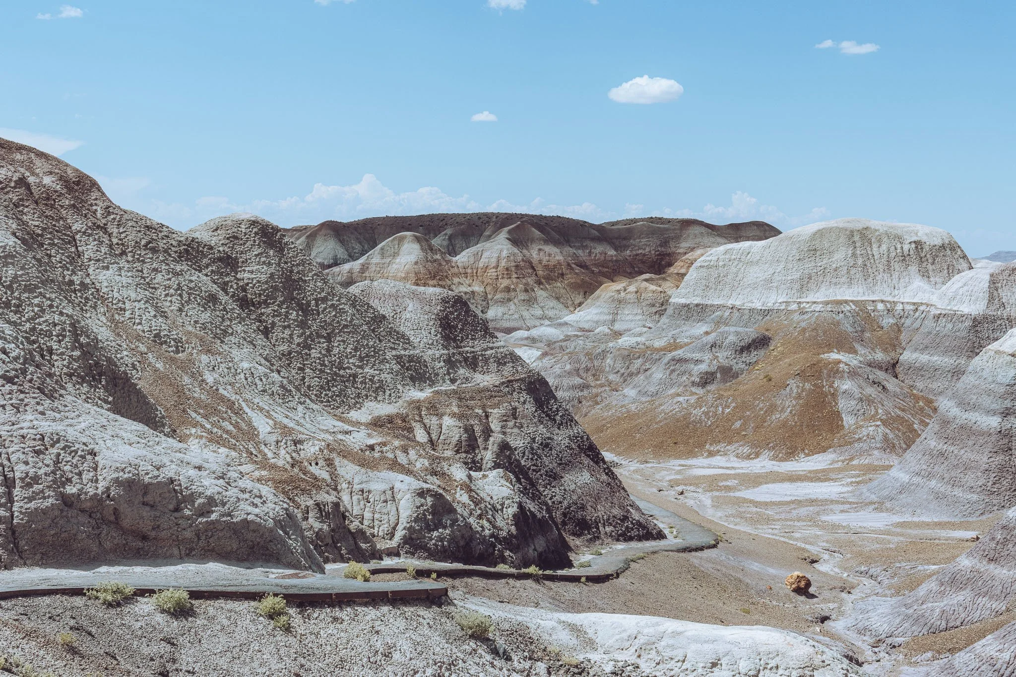 Blue-toned sand hills and layered formations in Arizona’s Painted Desert