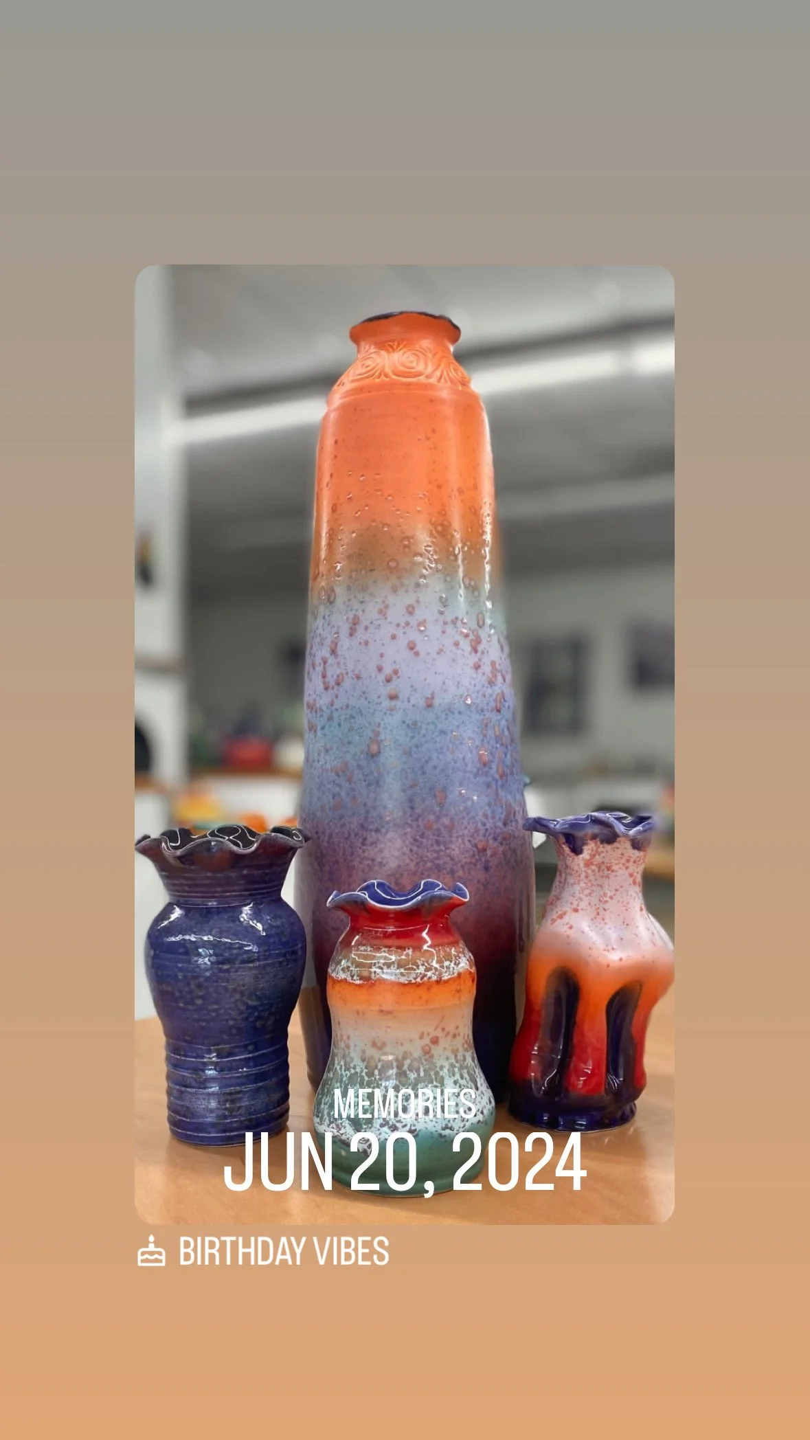 Colorful glass vases and a large decorative glass bottle on a wooden surface, with a blurred interior background. The text overlay reads "Memories Jun 20, 2024" and "Birthday Vibes."