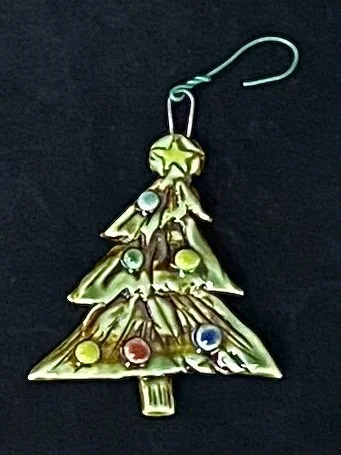 A Christmas tree-shaped ornament with colorful balloon it  and a hook for hanging.