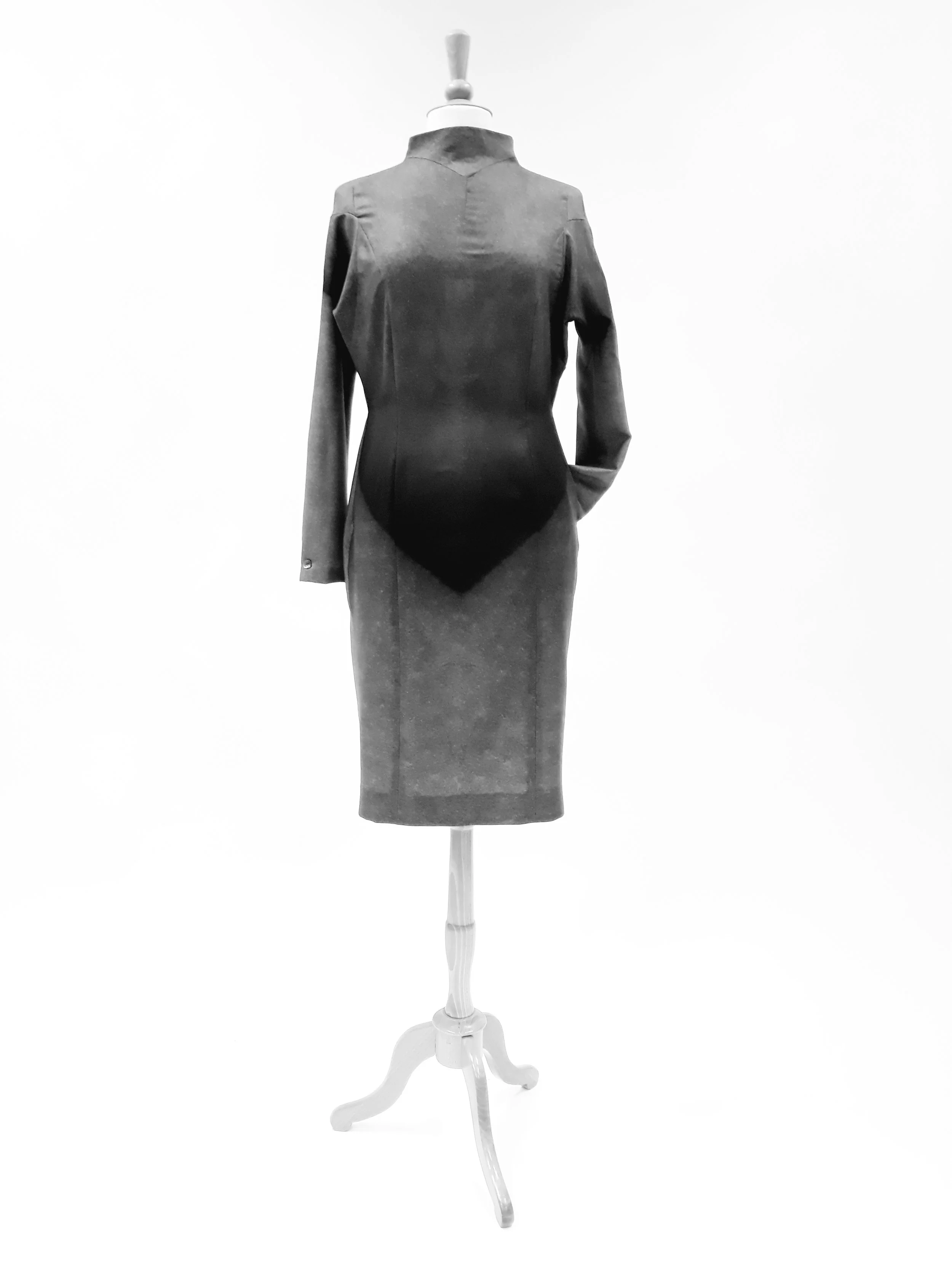 A mannequin wearing a men's suit on a white display stand against a plain white background.