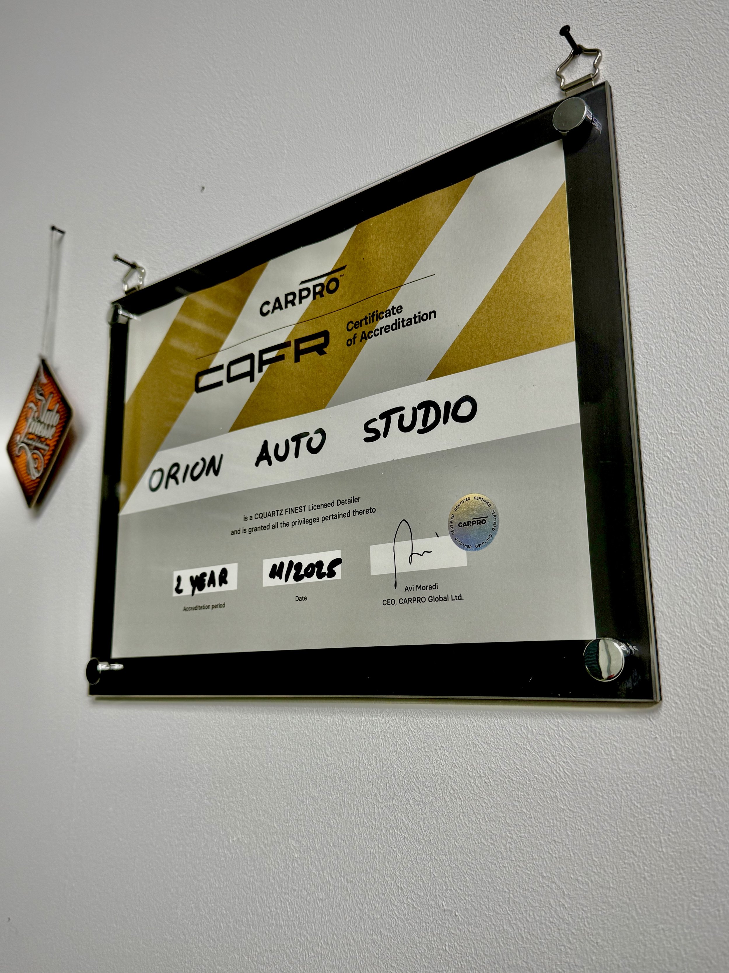 Certificate of accreditation for Orion Auto Studio issued by CarPro, signed by Avi Moradi, CEO of CarPro Global Ltd., with a date of 4/20/15, and an accreditation period of 2 years.