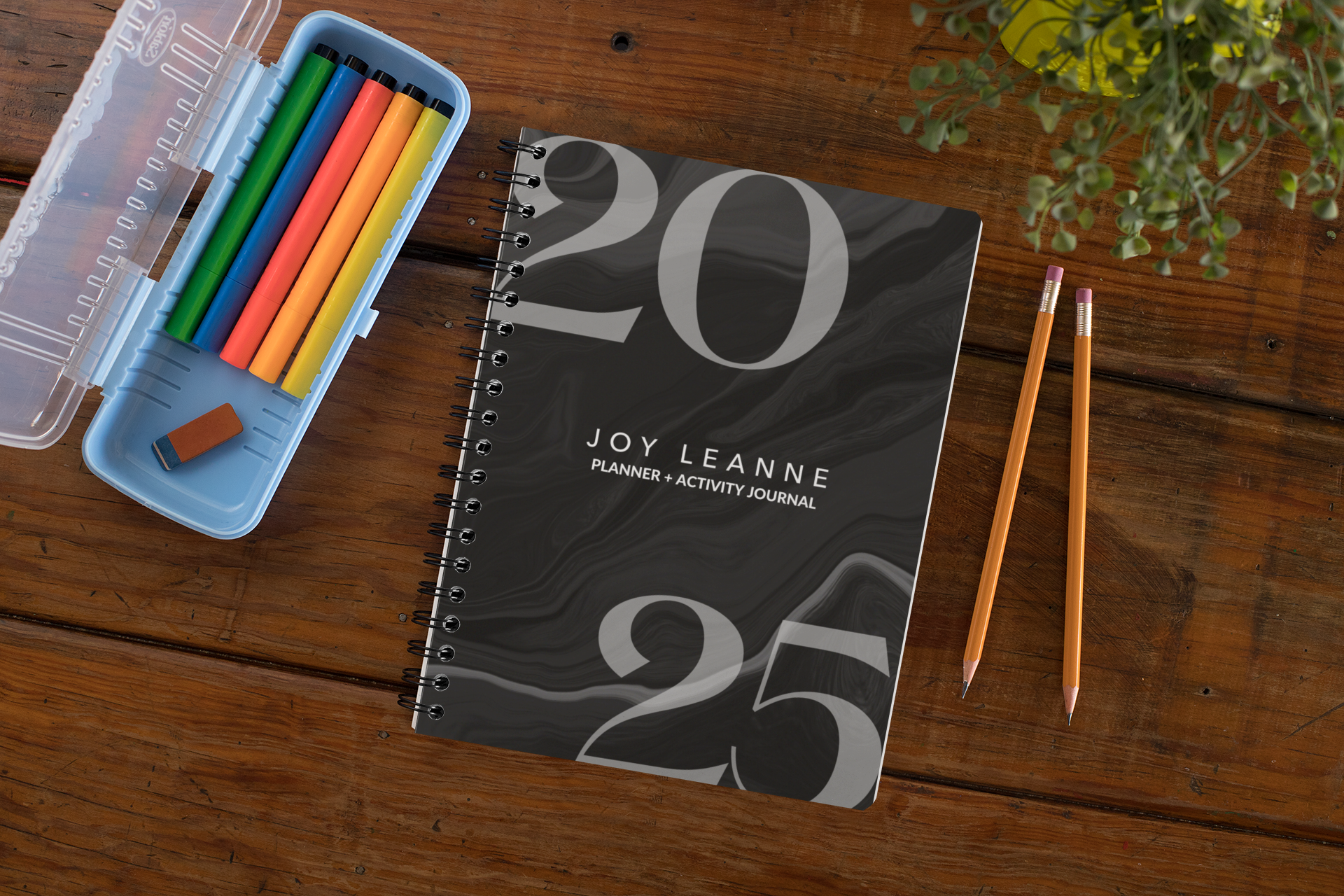 mockup-of-a-spiral-notebook-over-a-wooden-surface-29960.png