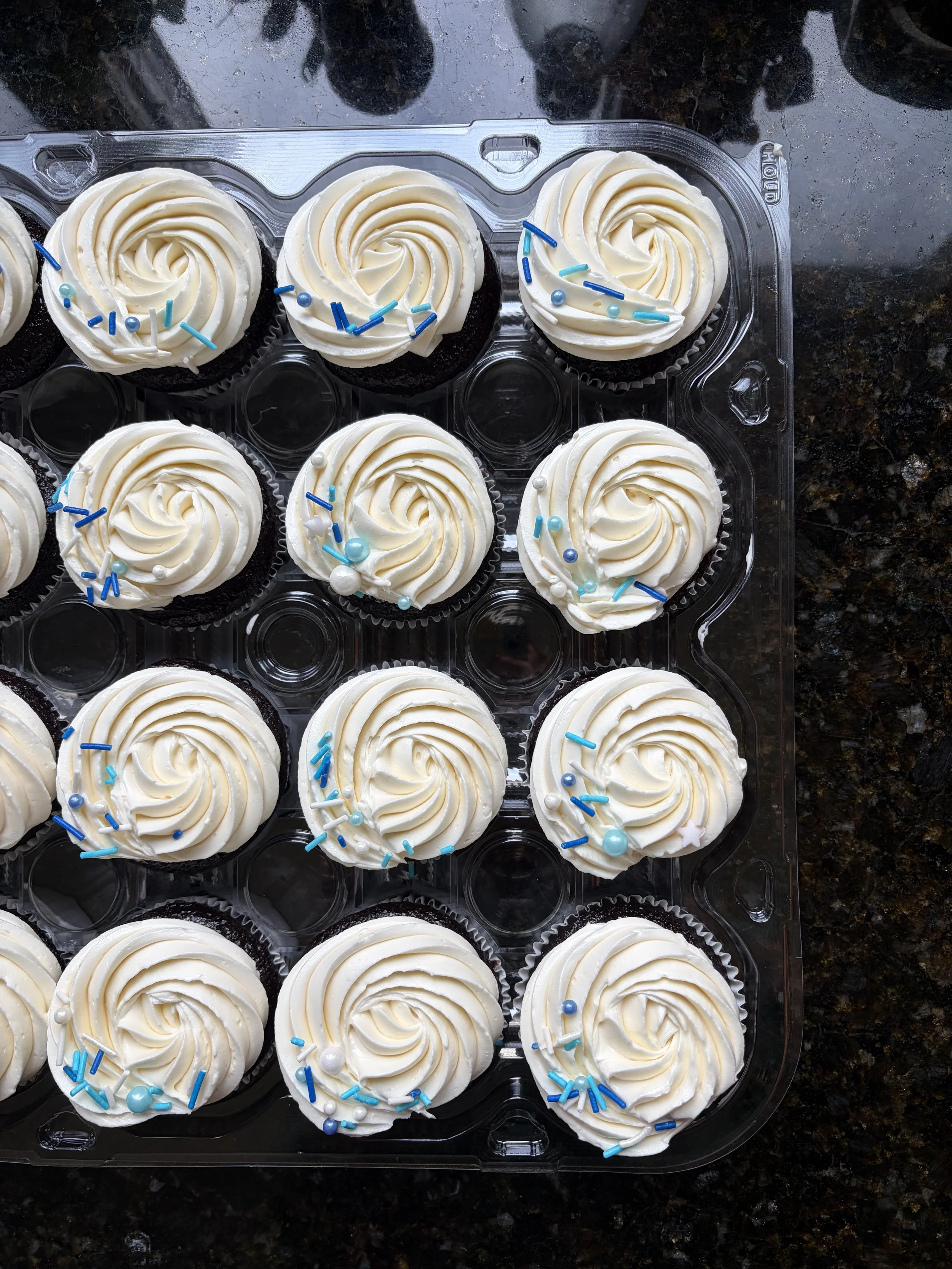 Cupcakes with vanilla buttercream and blue and white sprinkles