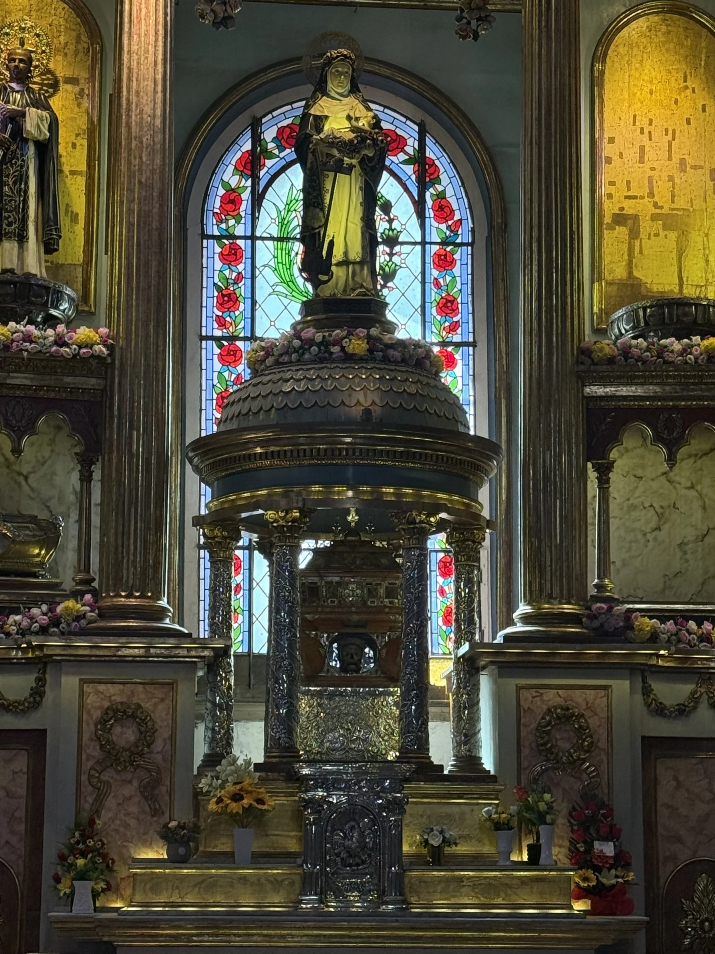 Creepy statues with human skulls displayed.