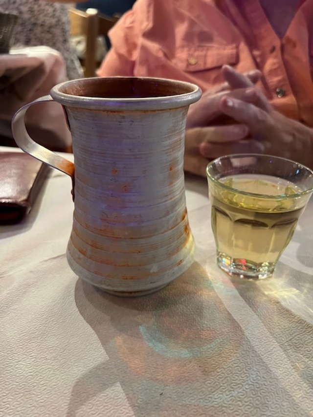 White wine with tin pitcher.