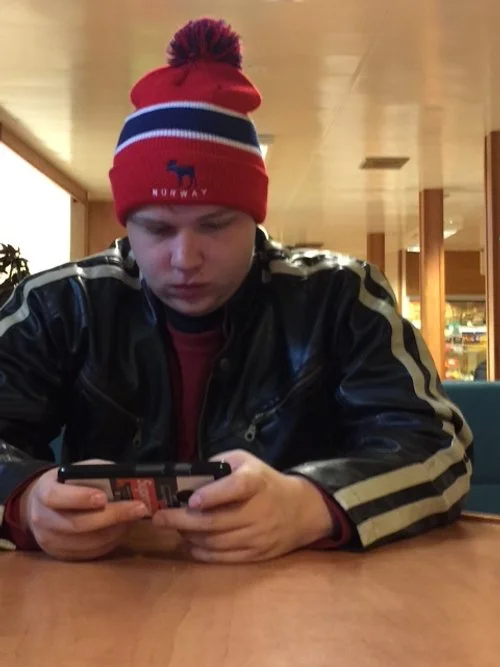 Wendell using his phone to pass the time.