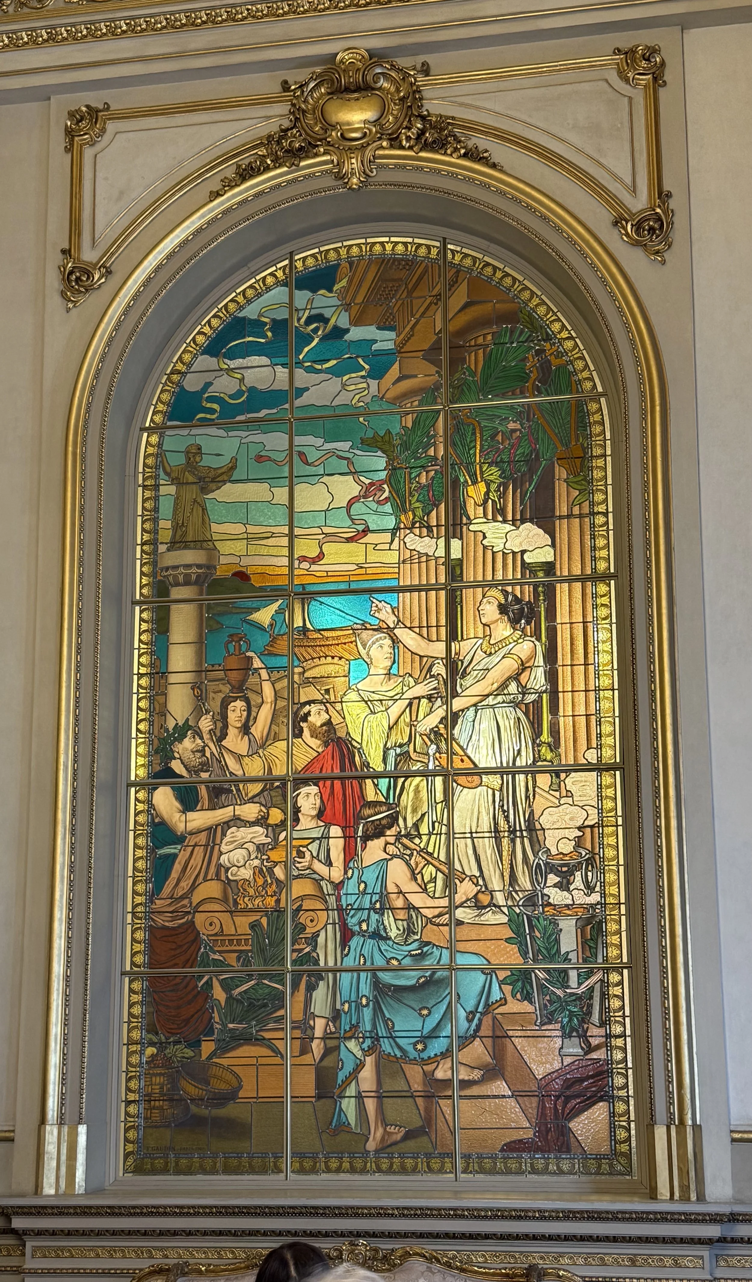 Stain glass pictures depicting celebration of the arts. 