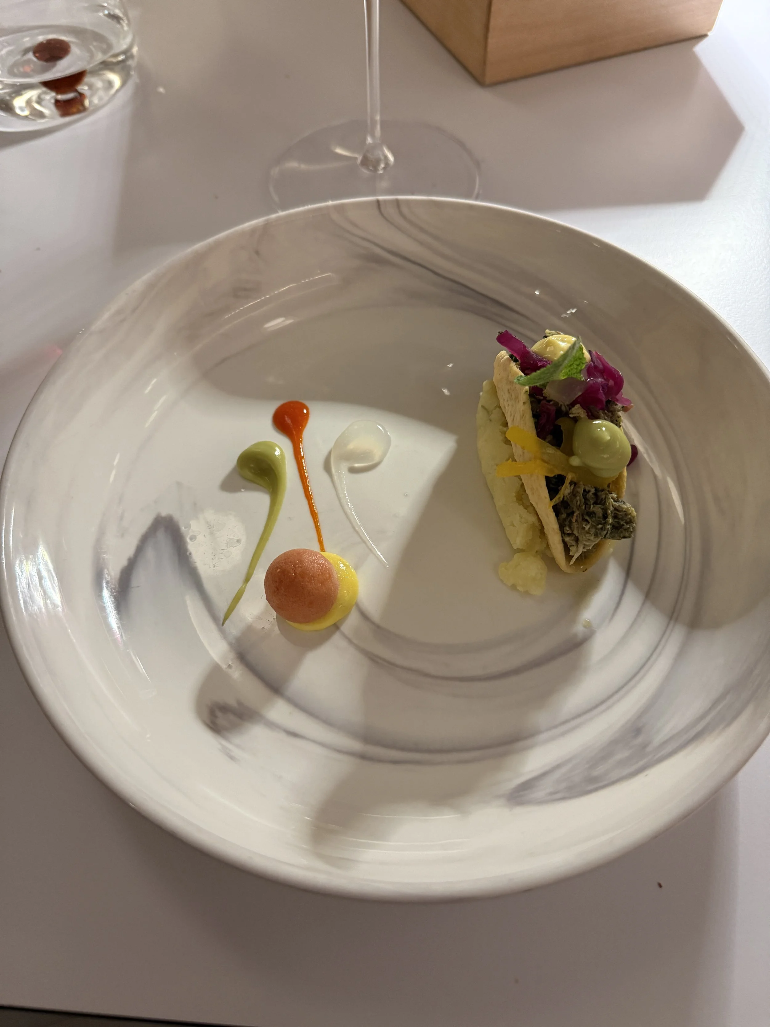 Taco filled with Neapolitan style braised greens and chicken, tomato ice-cream